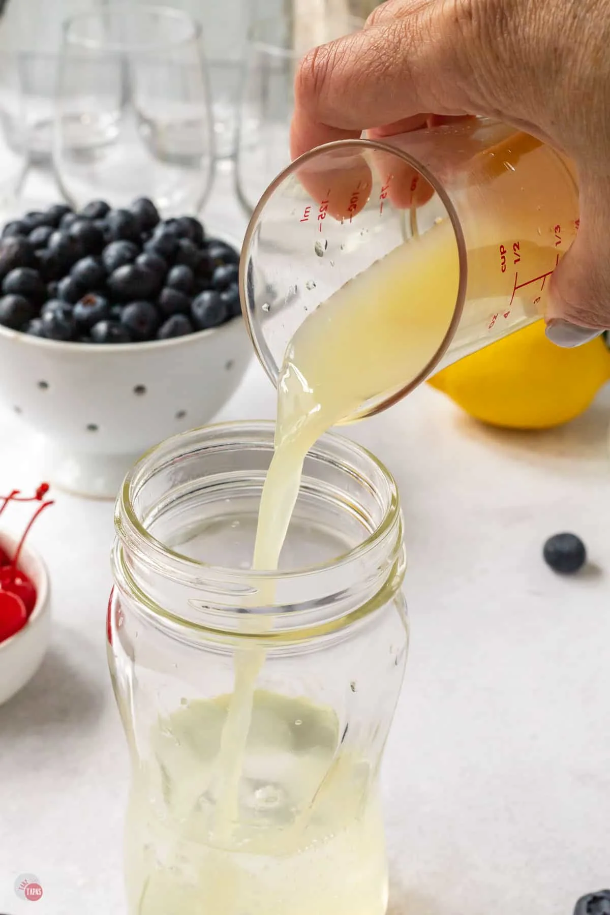 lemon juice pouring into a glass