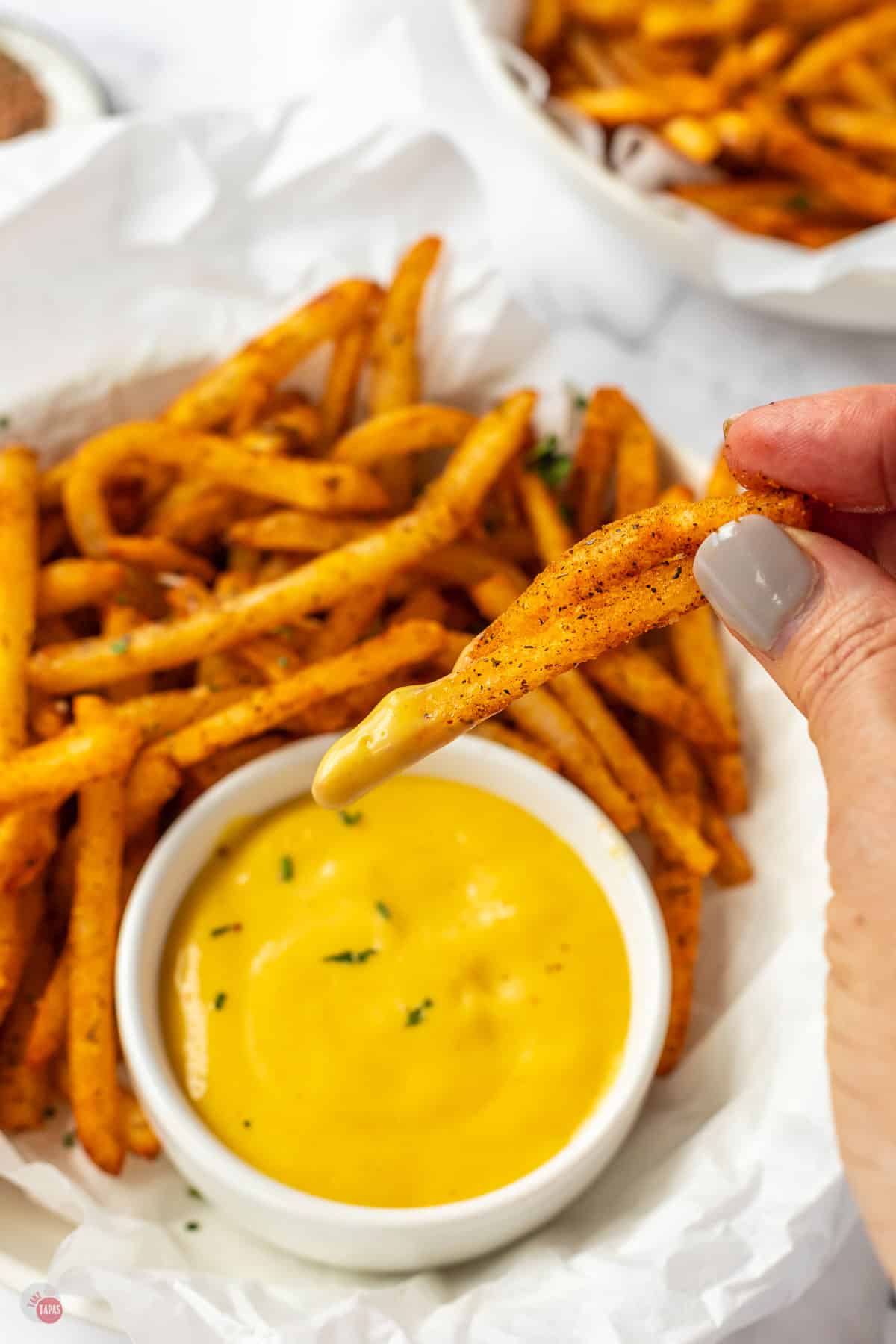 hand holding dipped french fry