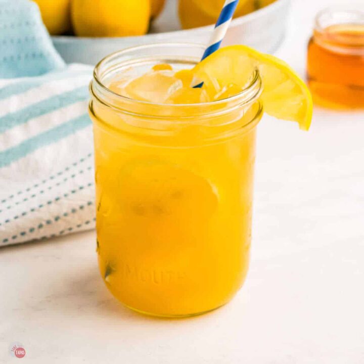 glass of pineapple bourbon lemonade with straw