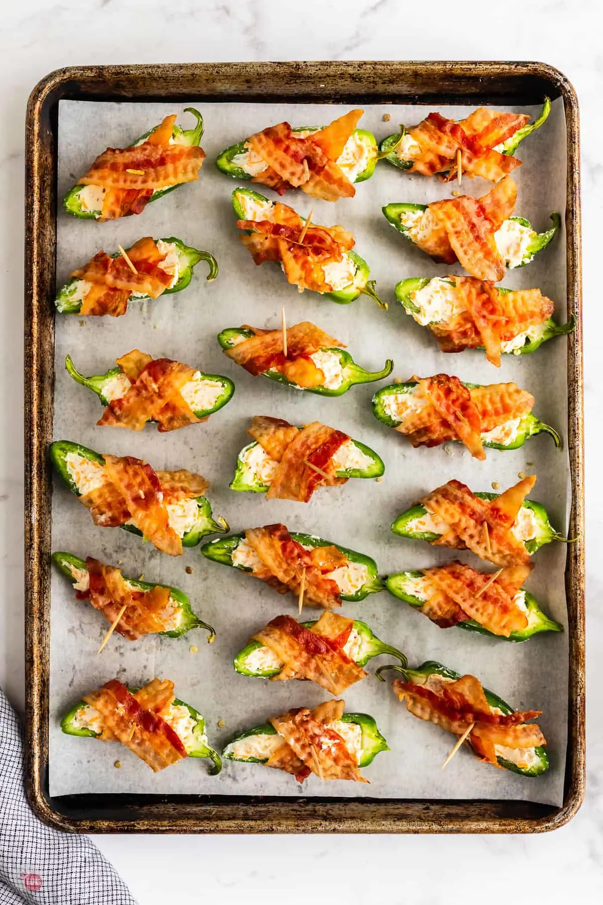 jalapeno poppers on a baking sheet