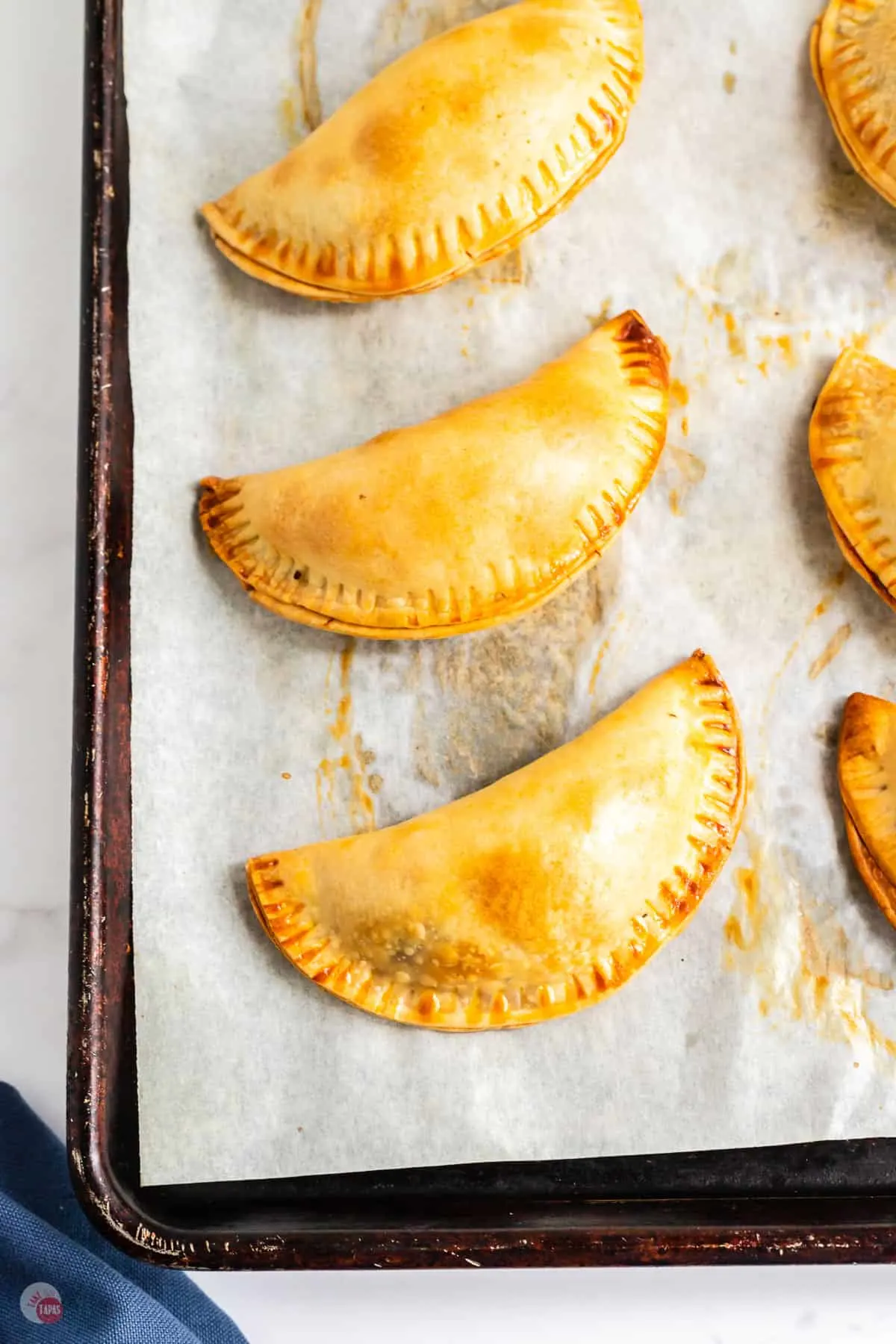 baked empanadas on a baking sheet