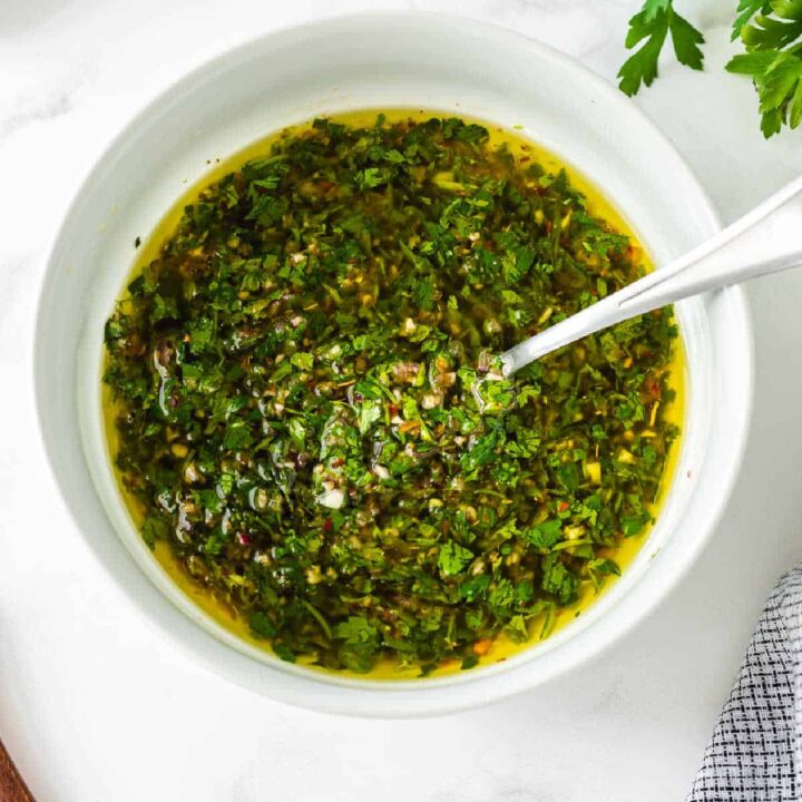 chimichurri in a bowl with a spoon