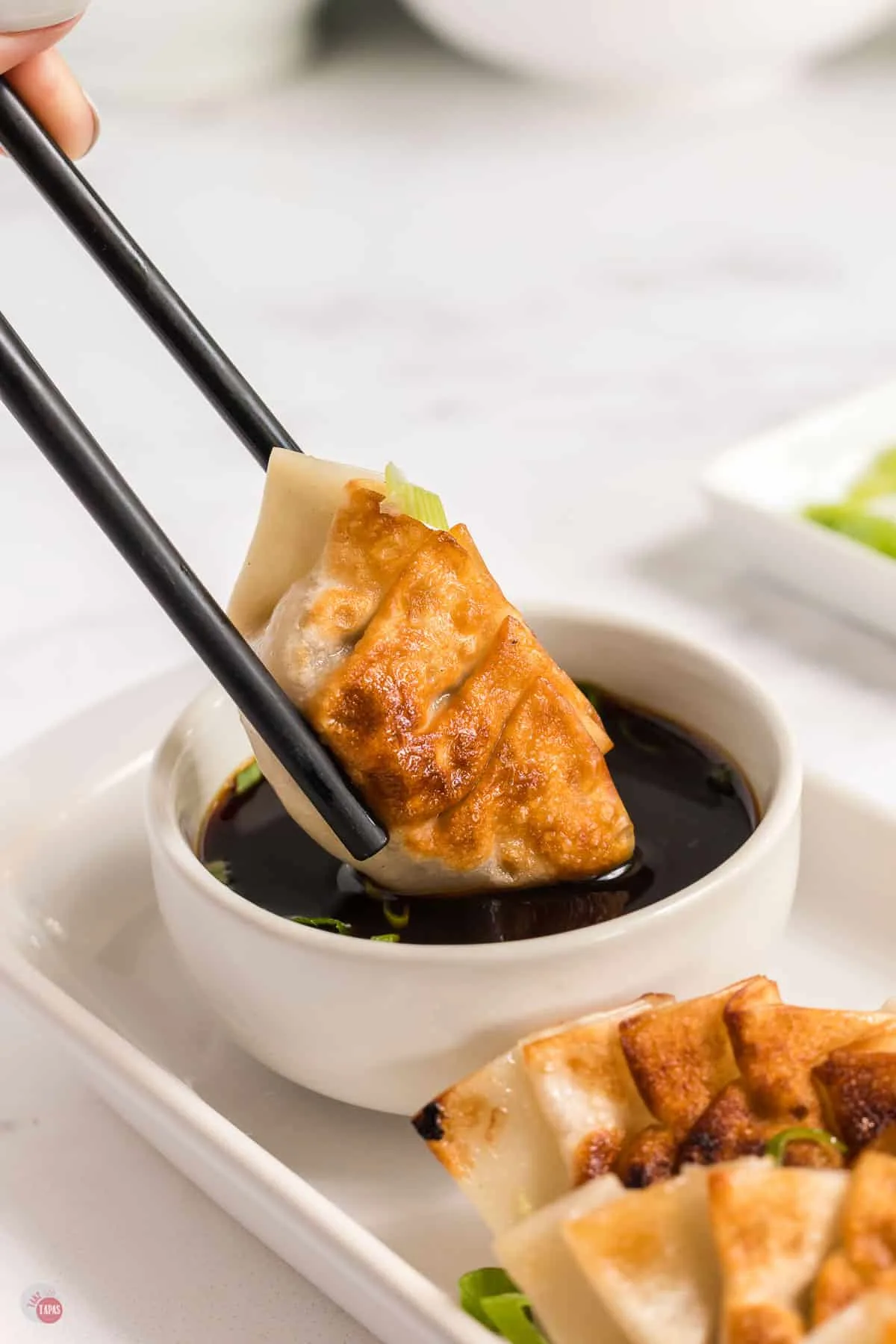 gyoza in dipping sauce with ponzu