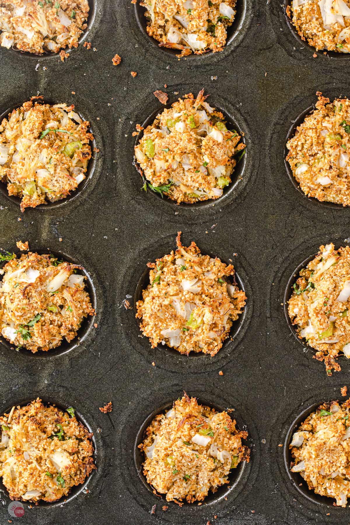 close up of Maryland style crab cakes in muffin pan