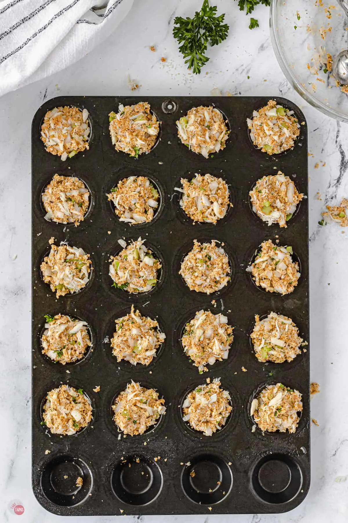 raw crab cakes in muffin pan