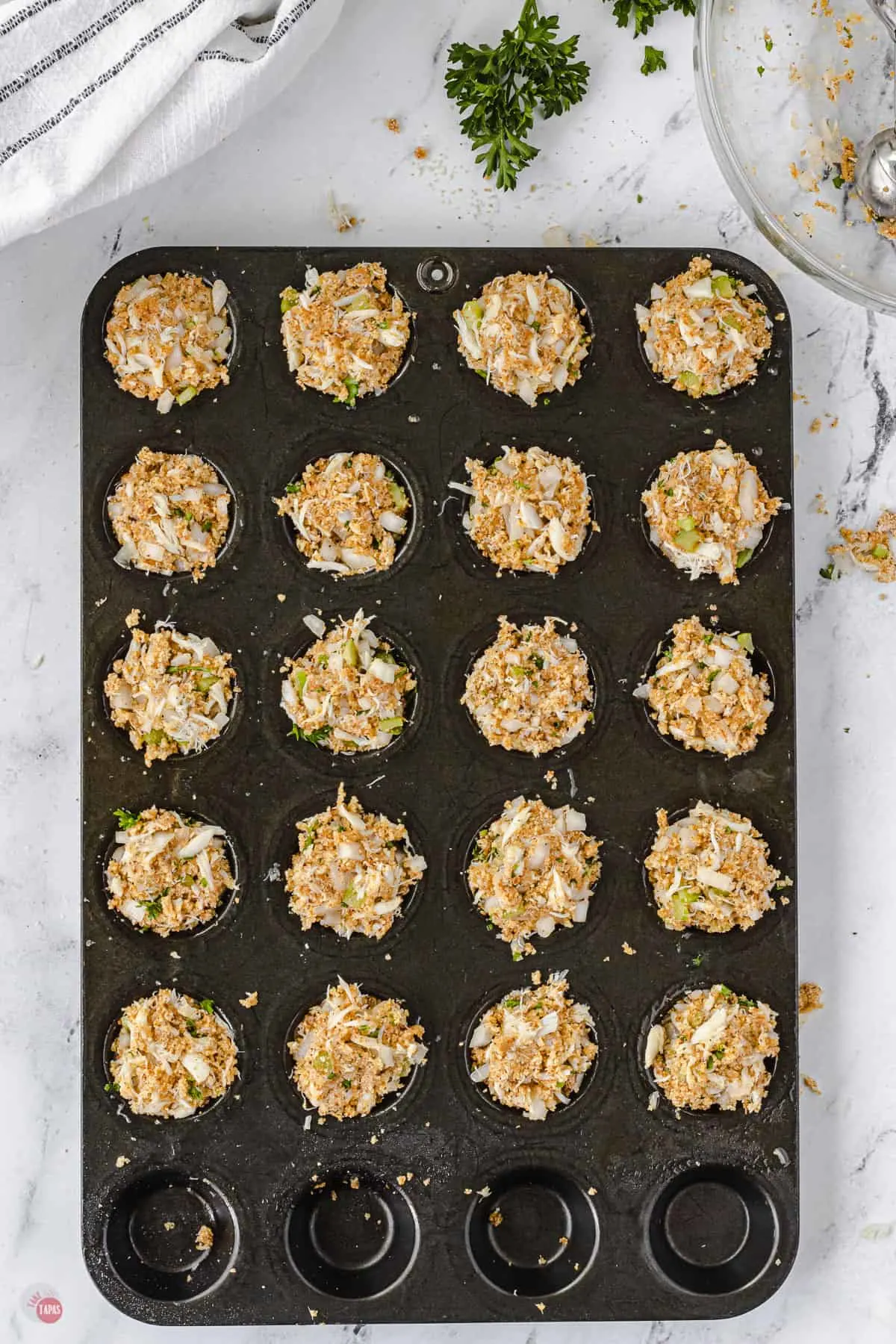 place crab cakes in the muffin pan