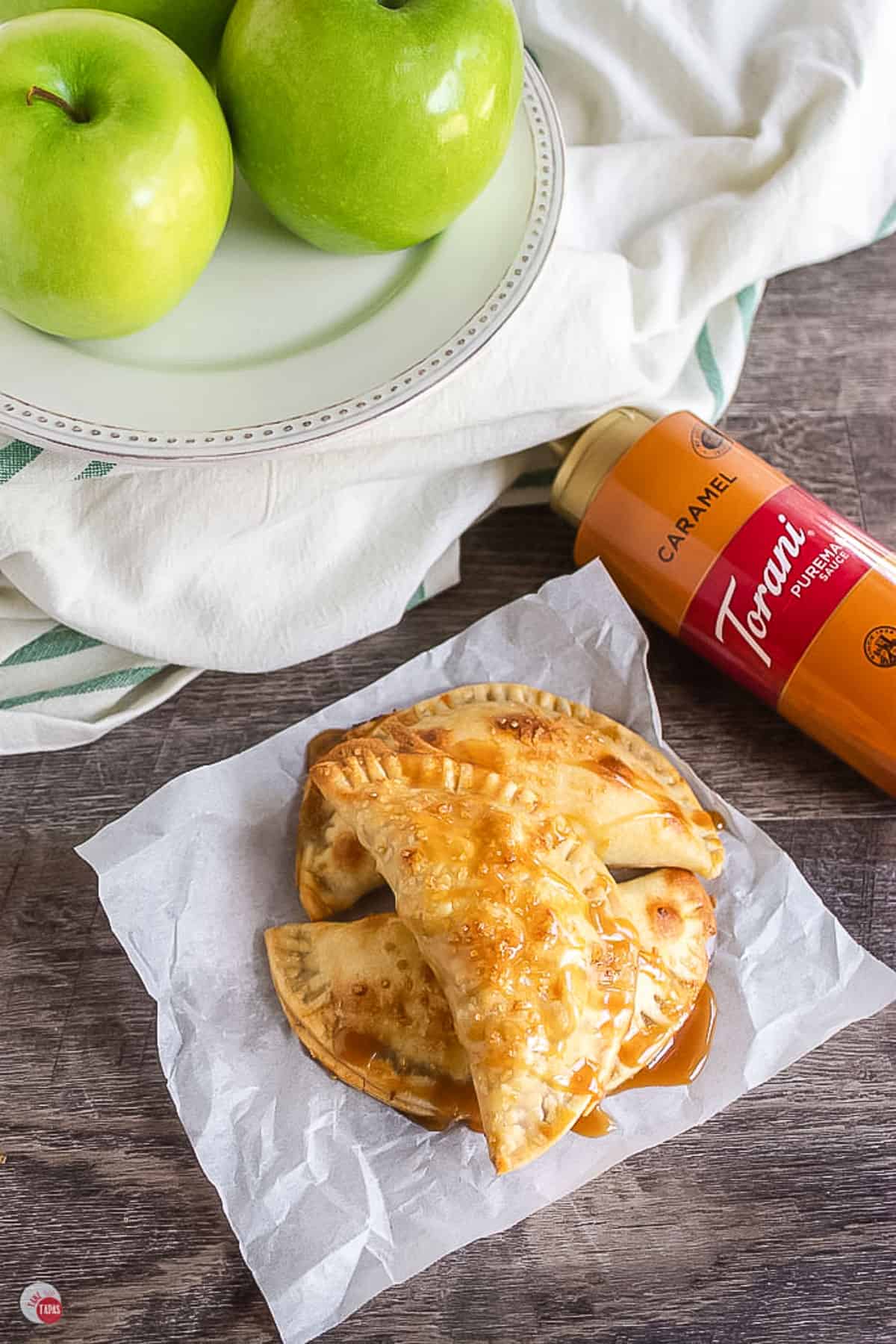 apple empanadas on parchment paper