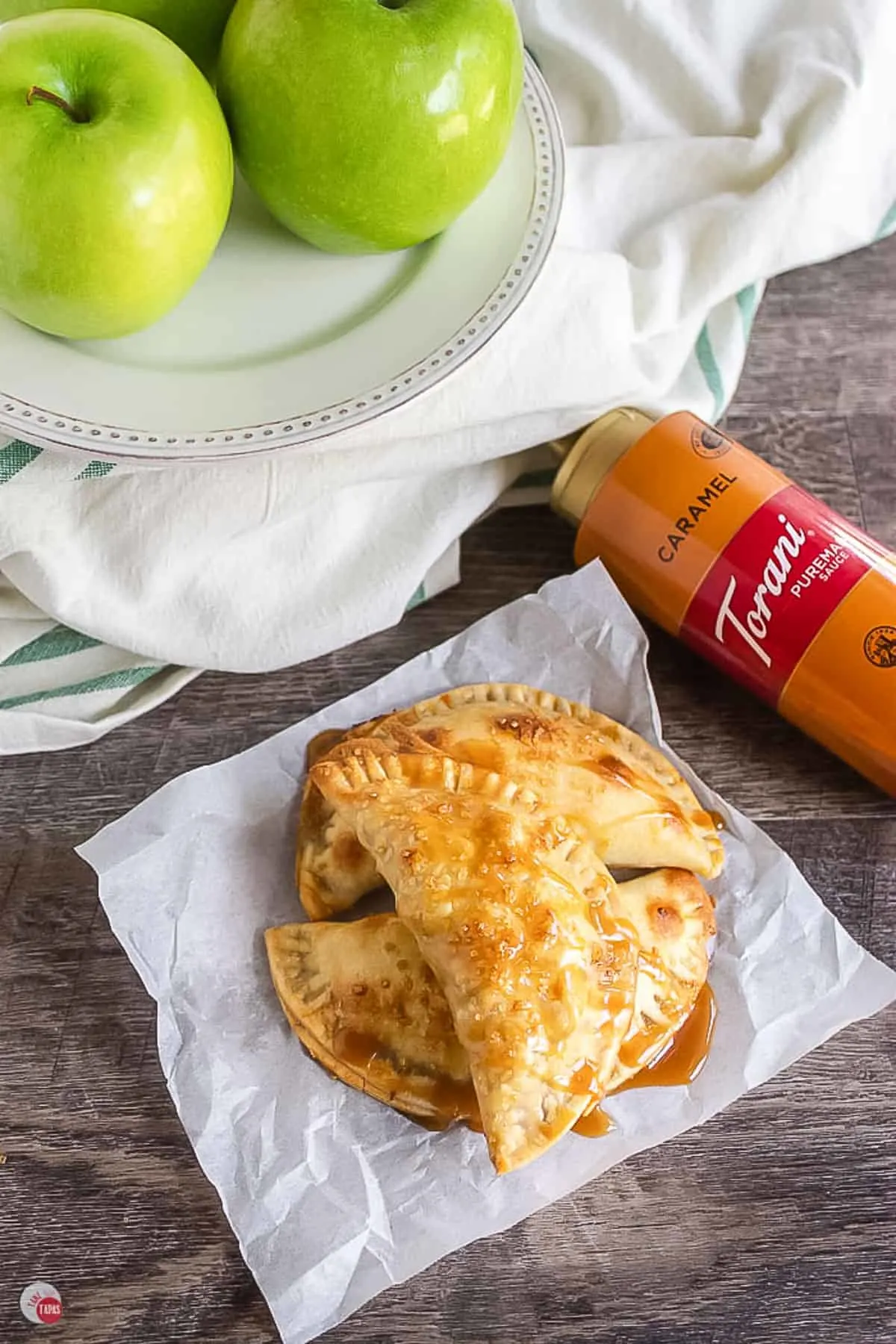 apple empanadas on parchment paper