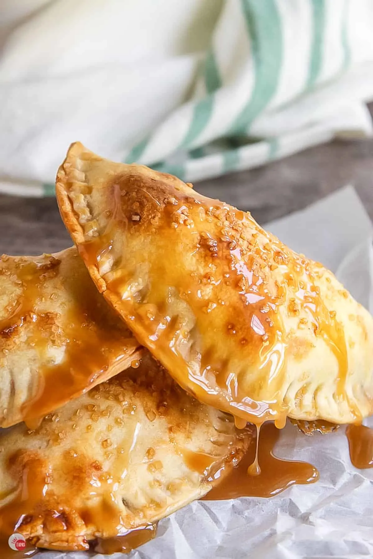 apple empanadas on parchment paper