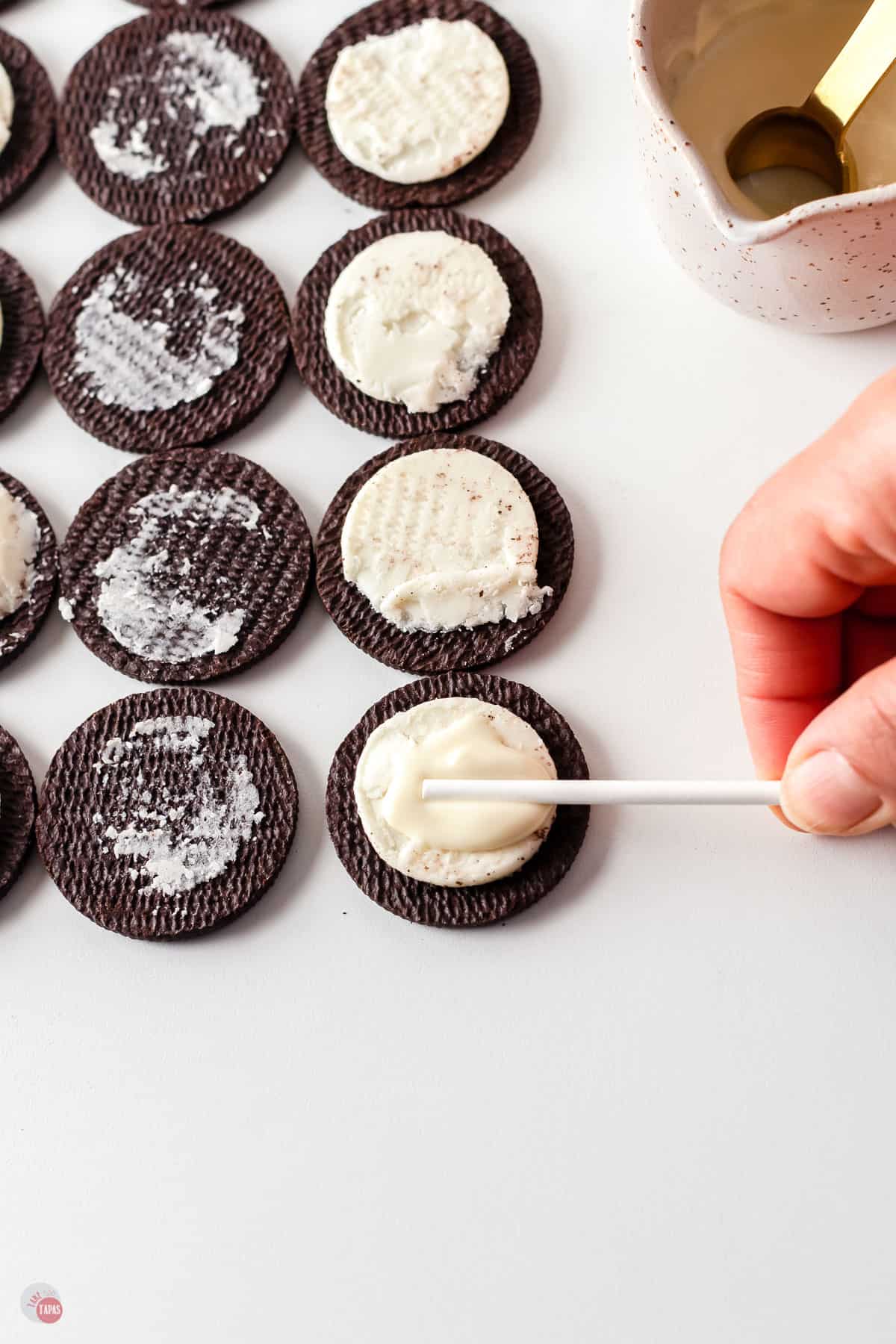 open oreos and a lollipop stick