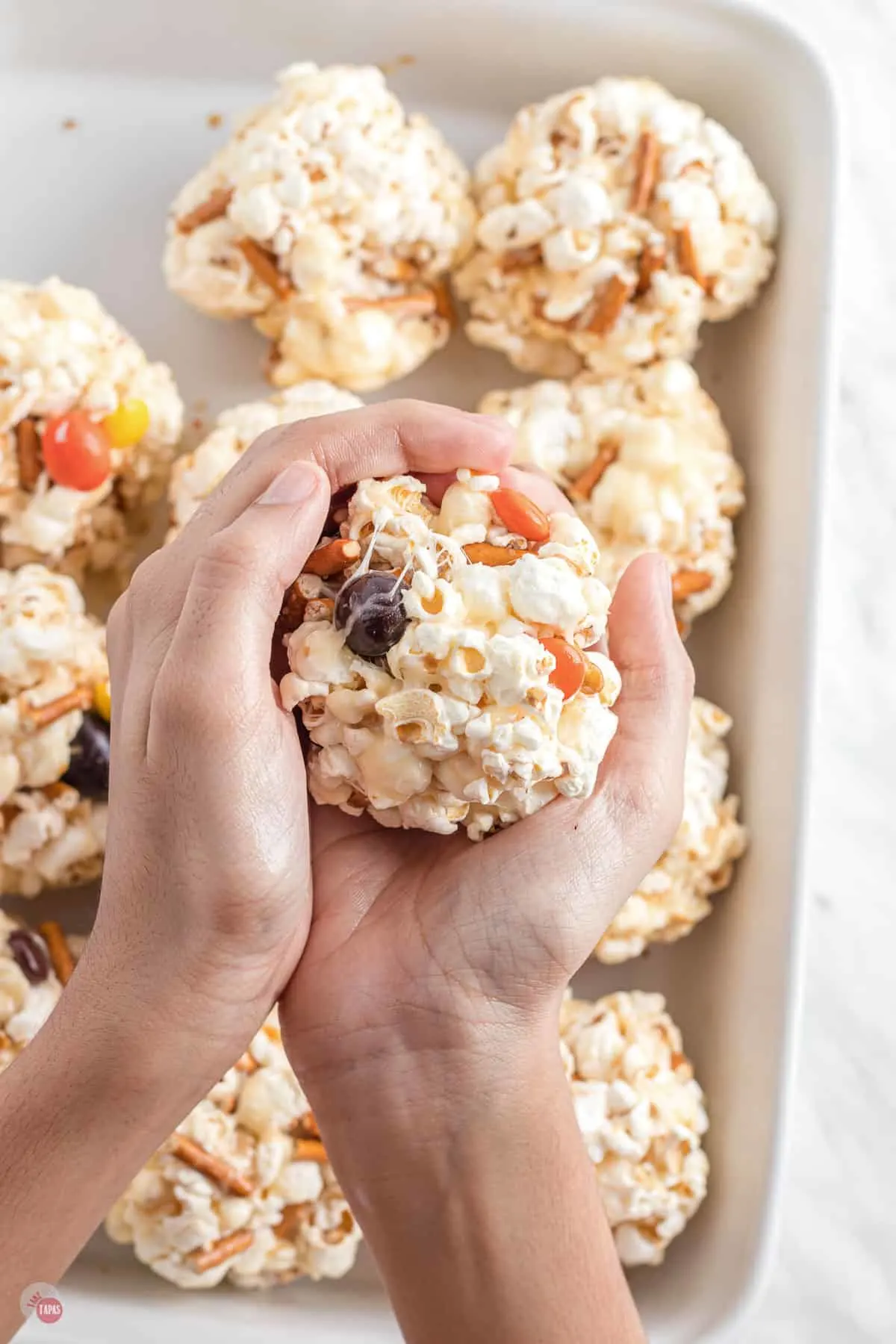 popcorn ball in two hands
