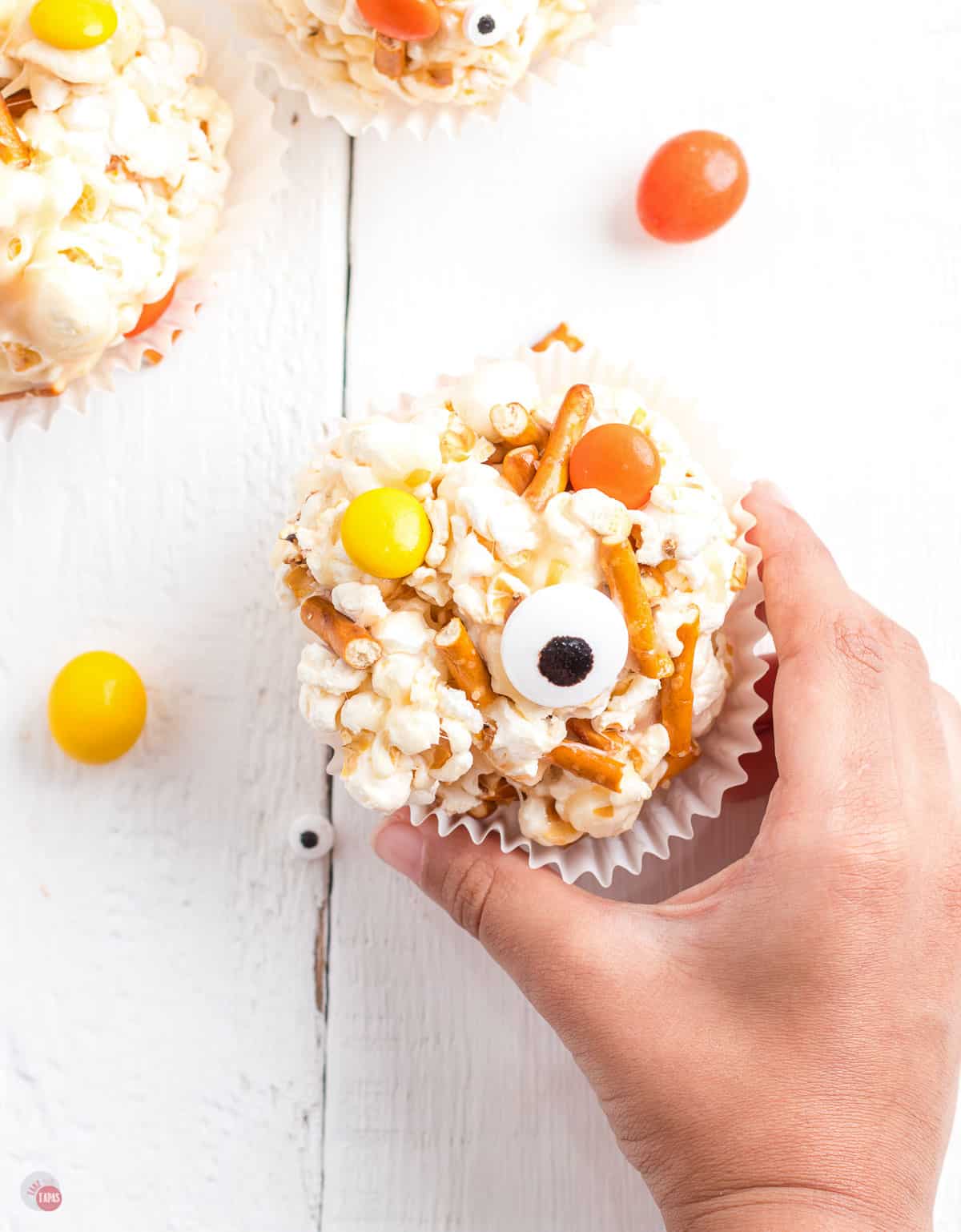 hand holding popcorn ball