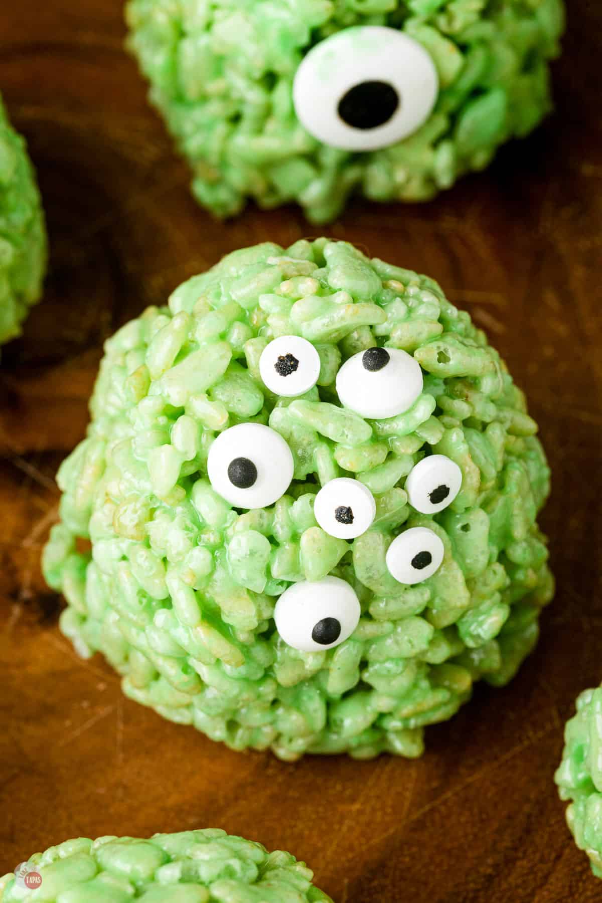 halloween rice krispie treats on a wood plank