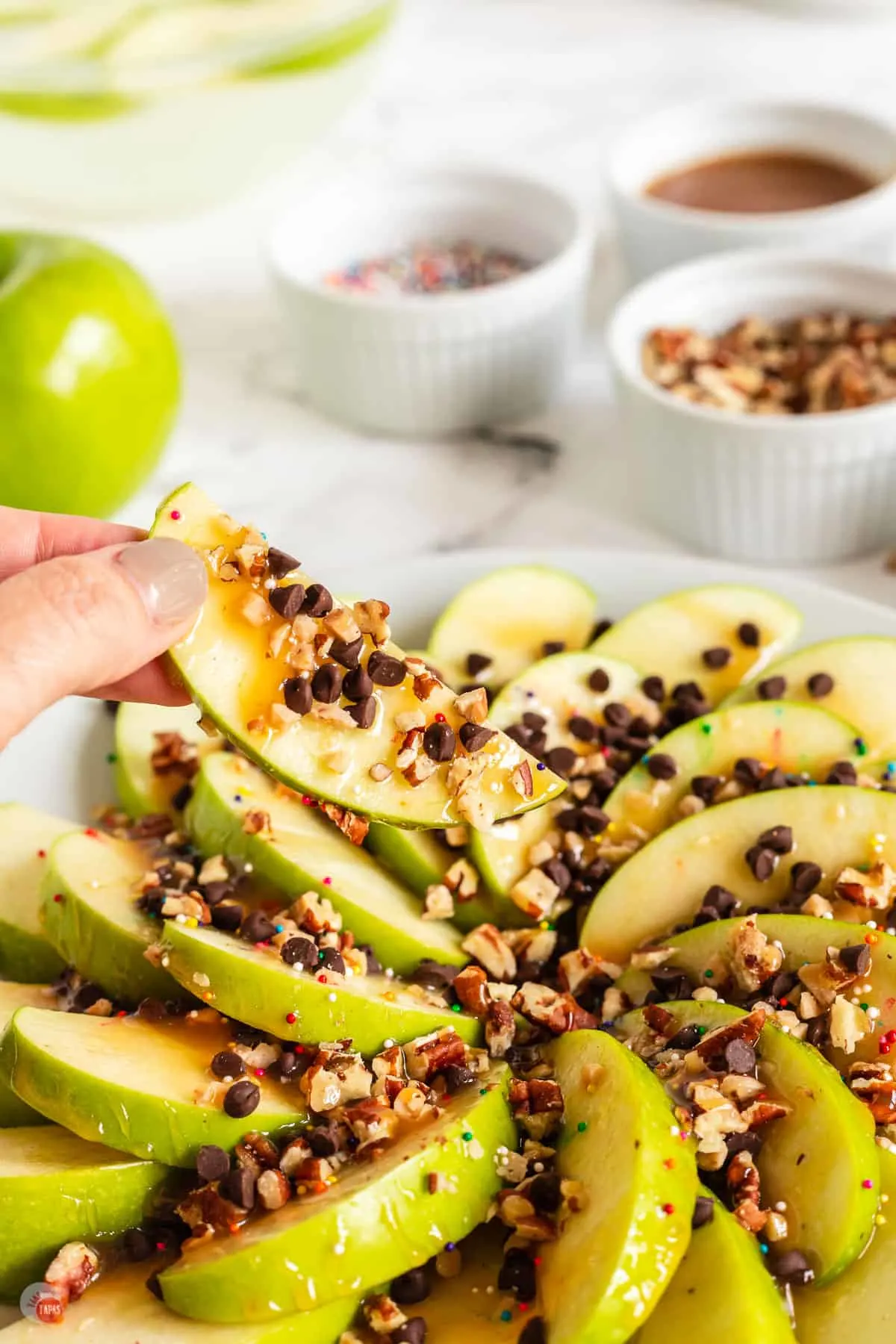 hand holding an apple nacho