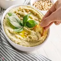 bowl of hummus with cracker