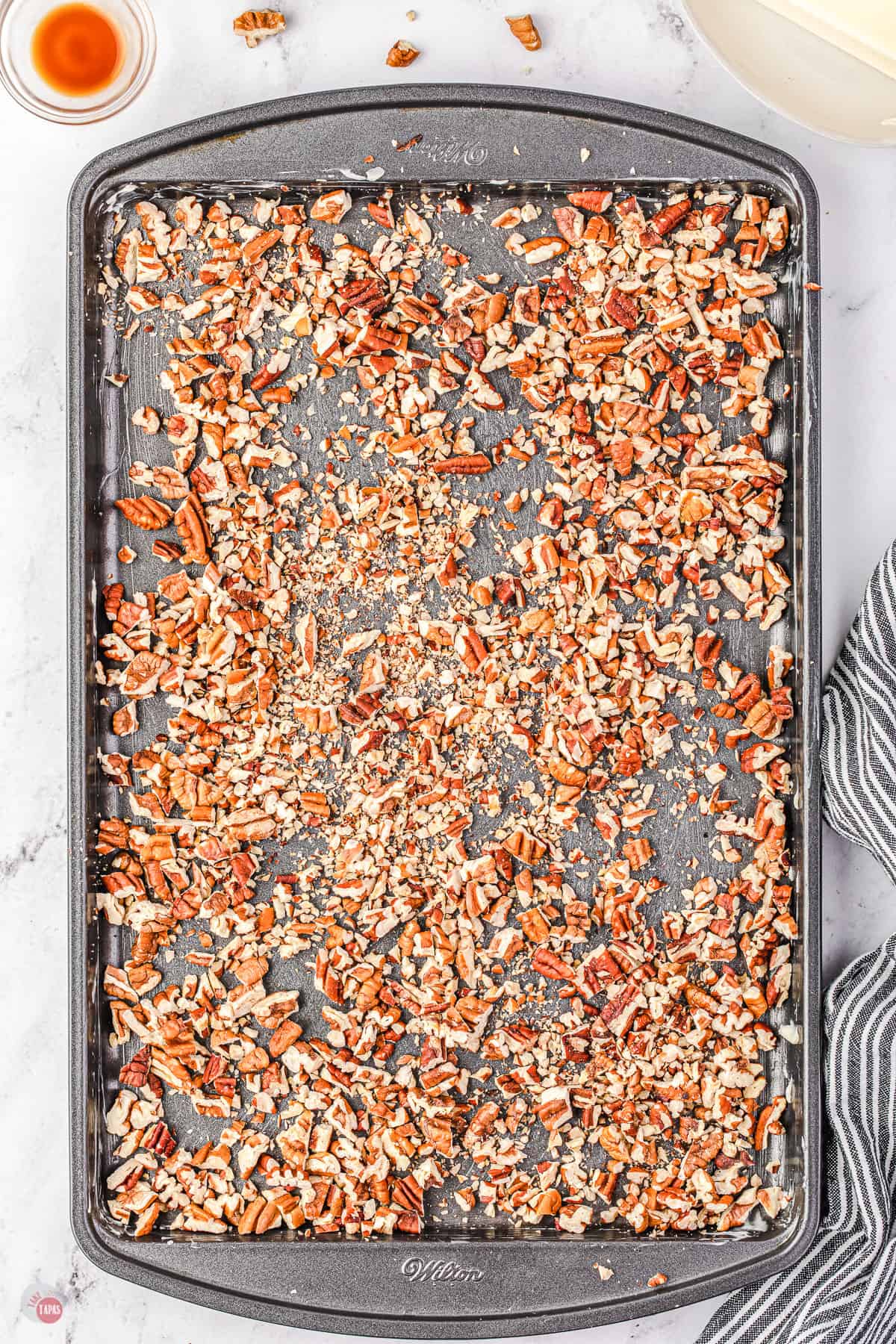 chopped pecans on a baking sheet