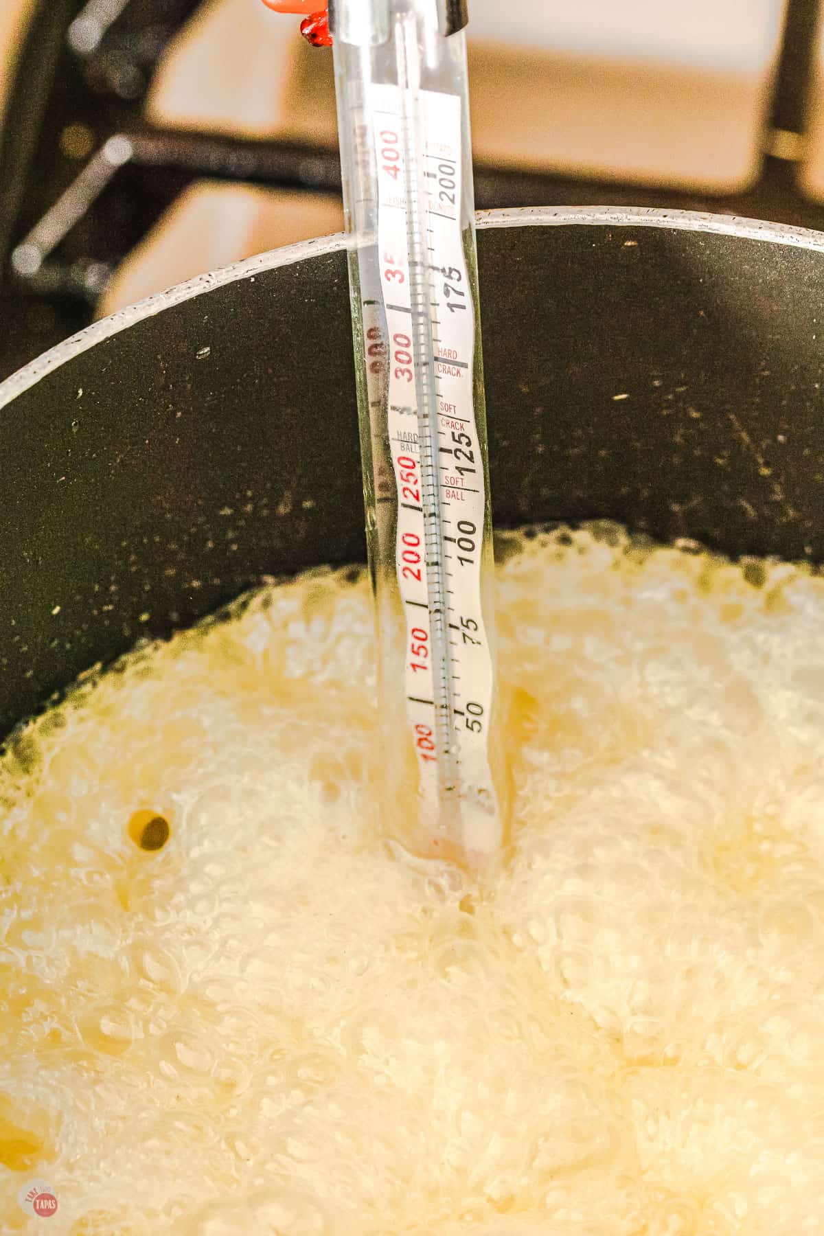 sugar boiling with thermometer in pot