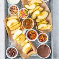 tray with apples and toppings