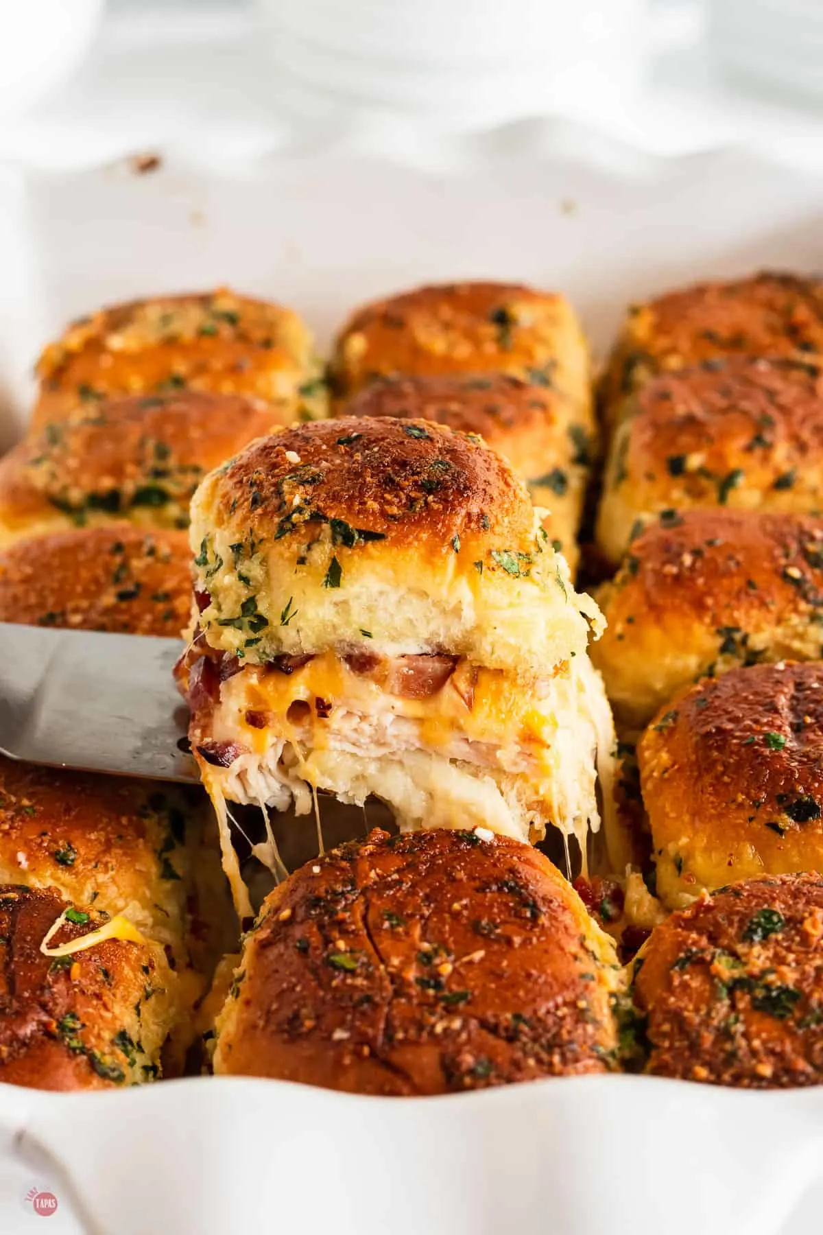 chicken sliders in a pan with a spatula