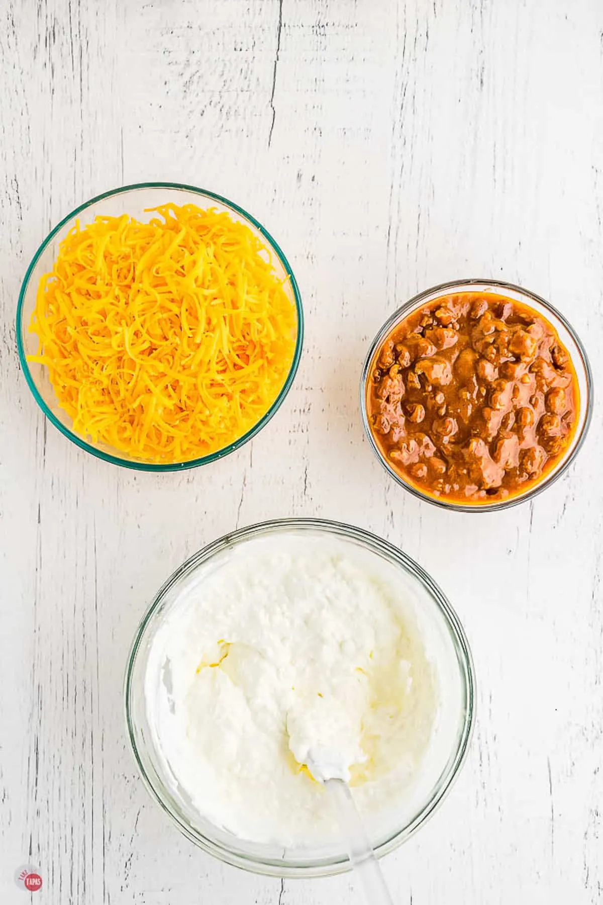 cream cheese, chili, and cheese in bowls