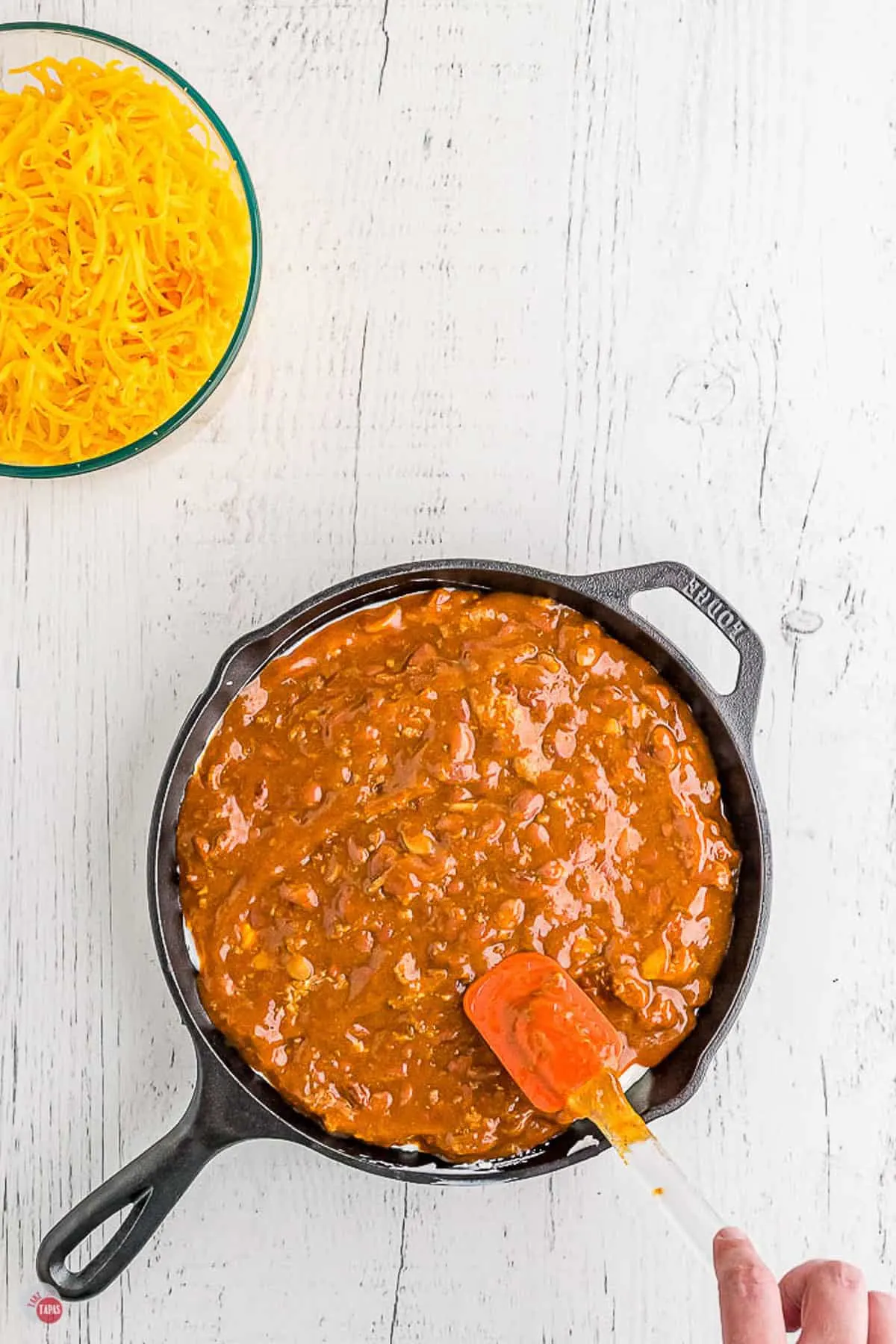 chili in a skillet with a spatula