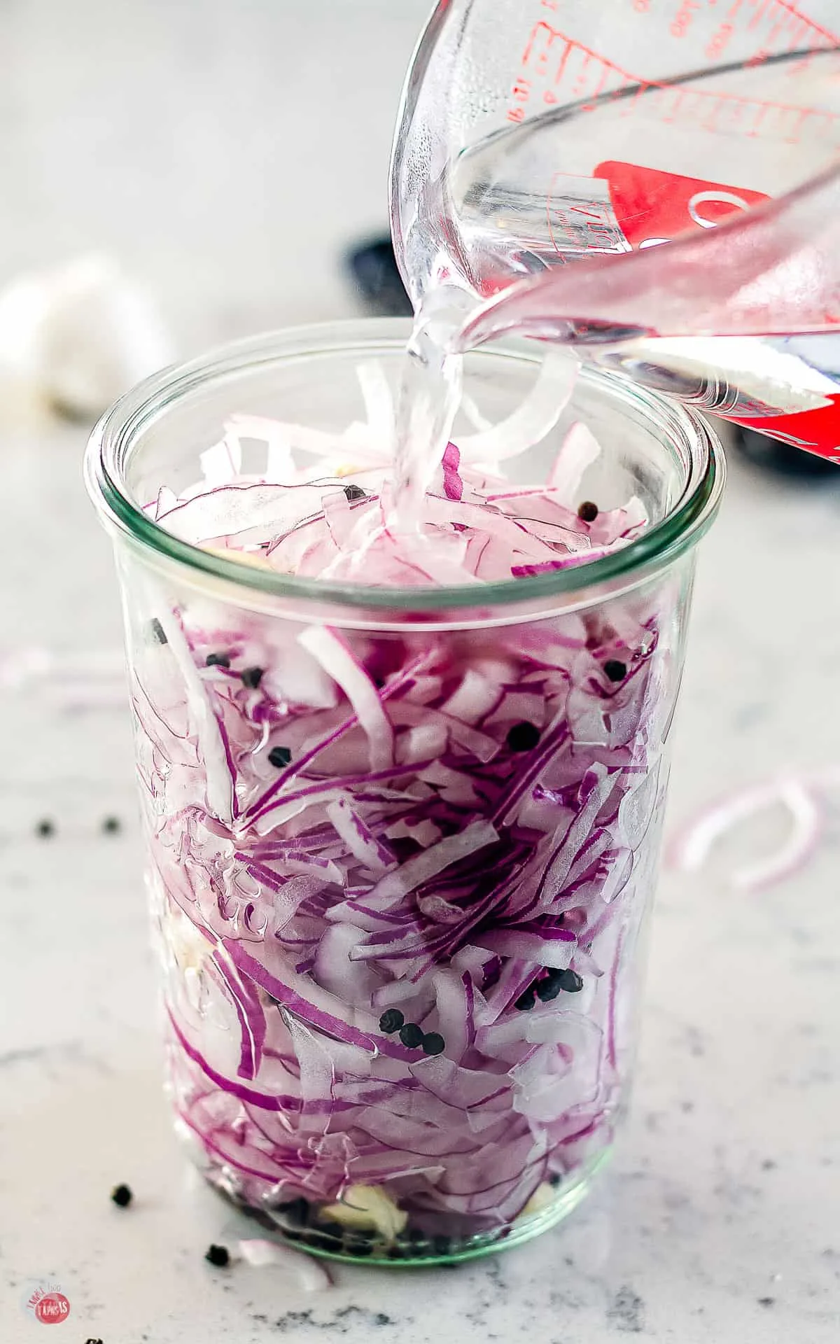 vinegar pouring into a jar