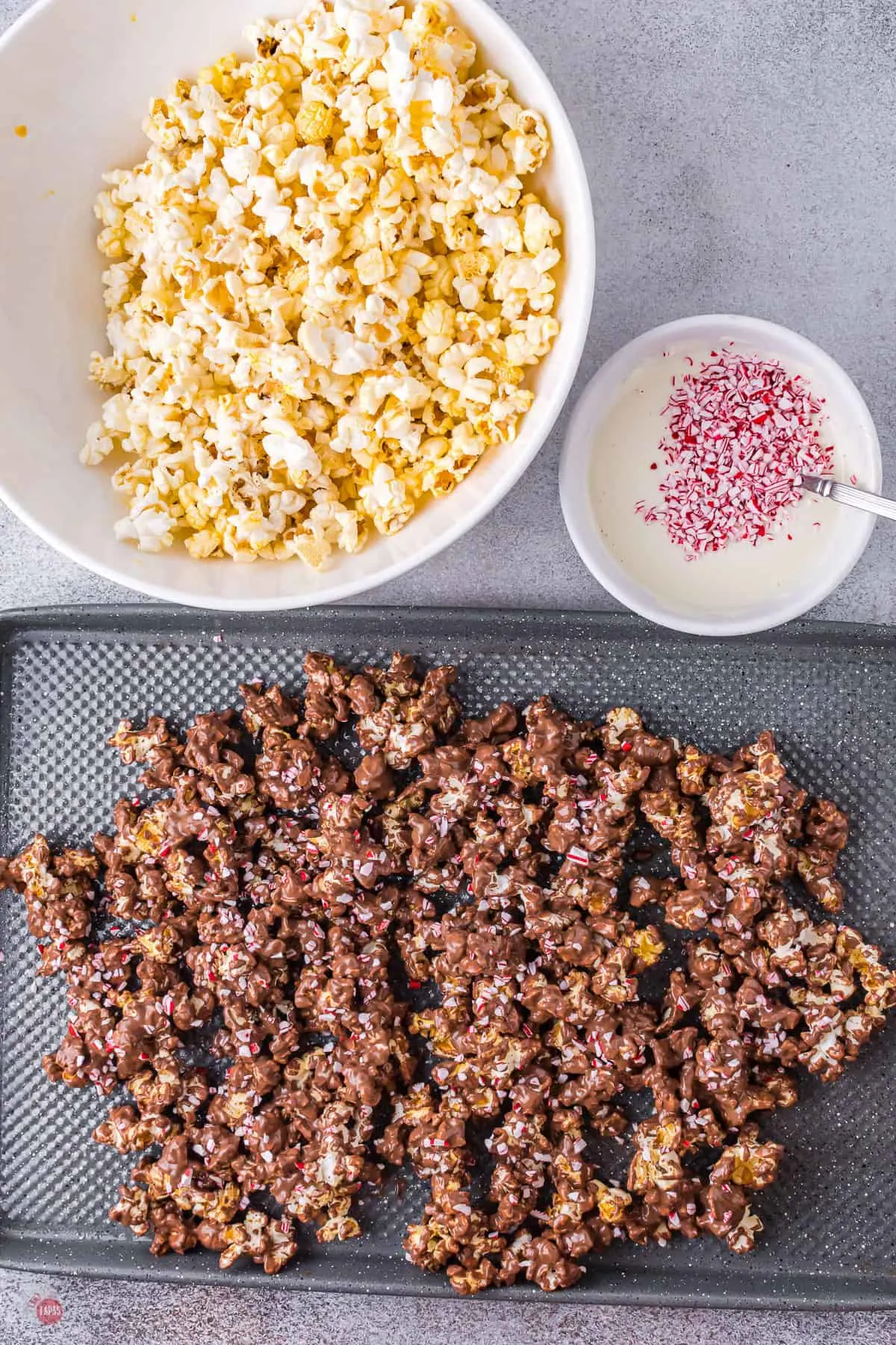 chocolate covered popcorn on a baking sheet