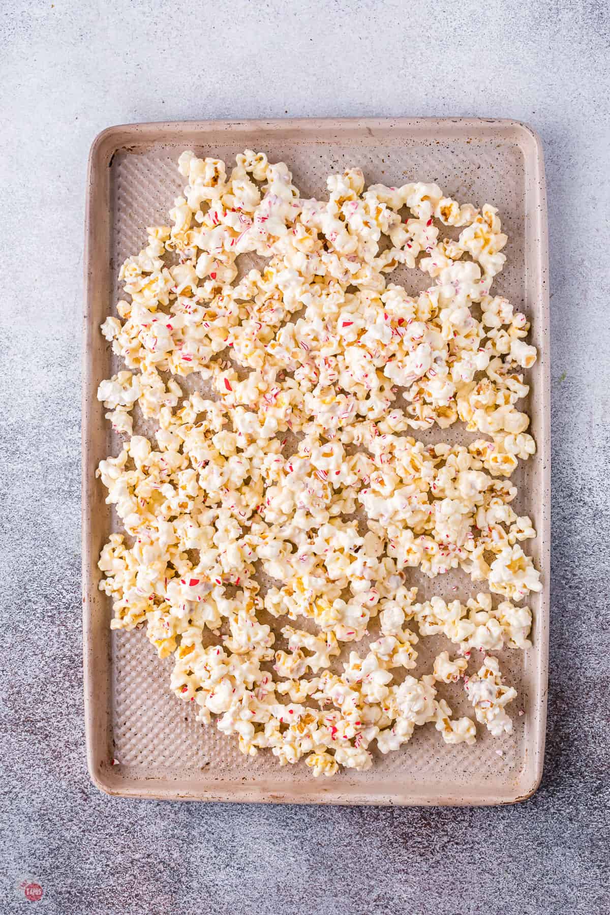 white chocolate popcorn on a baking sheet