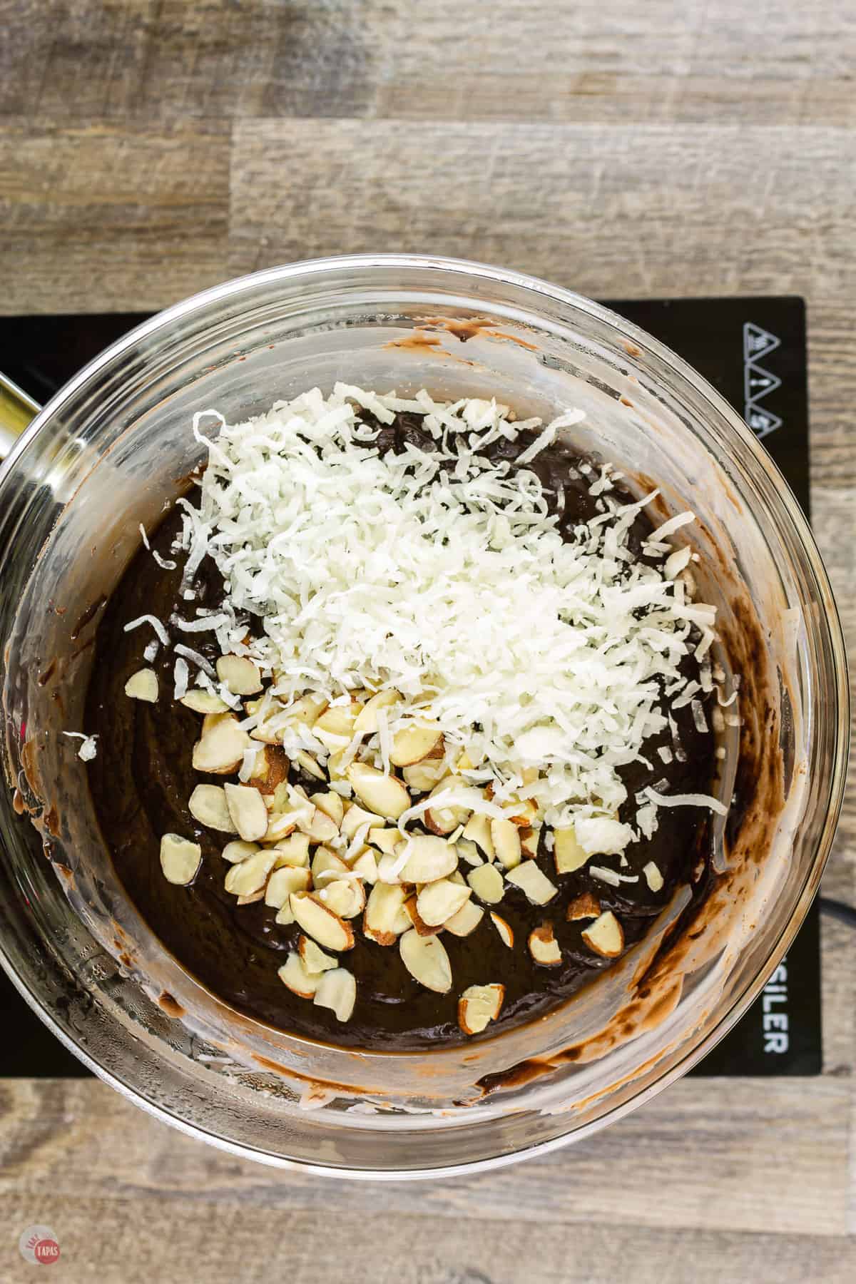 overhead picture of melted chocolate with almonds and coconut