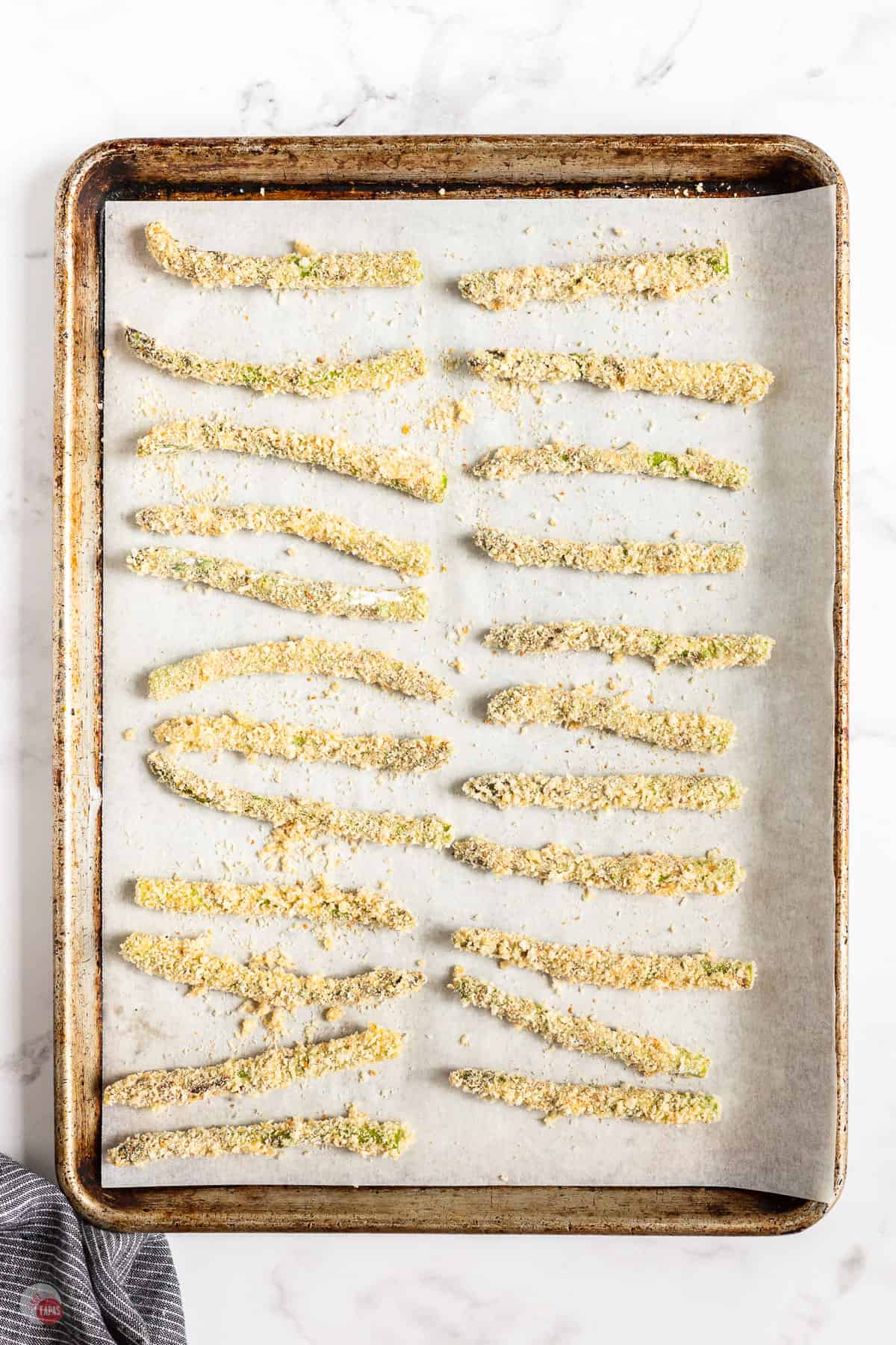coated asparagus on a baking sheet