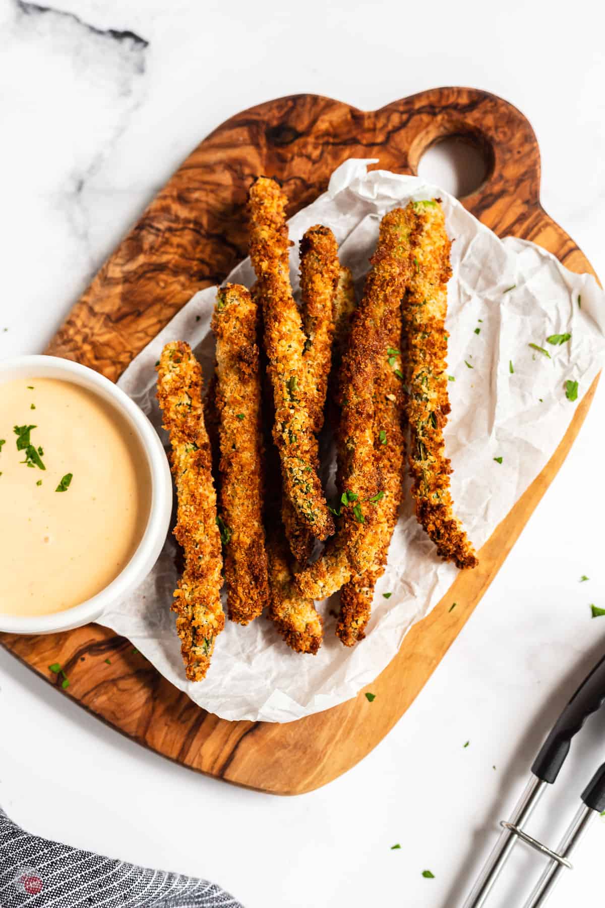 wood board of asparagus fries