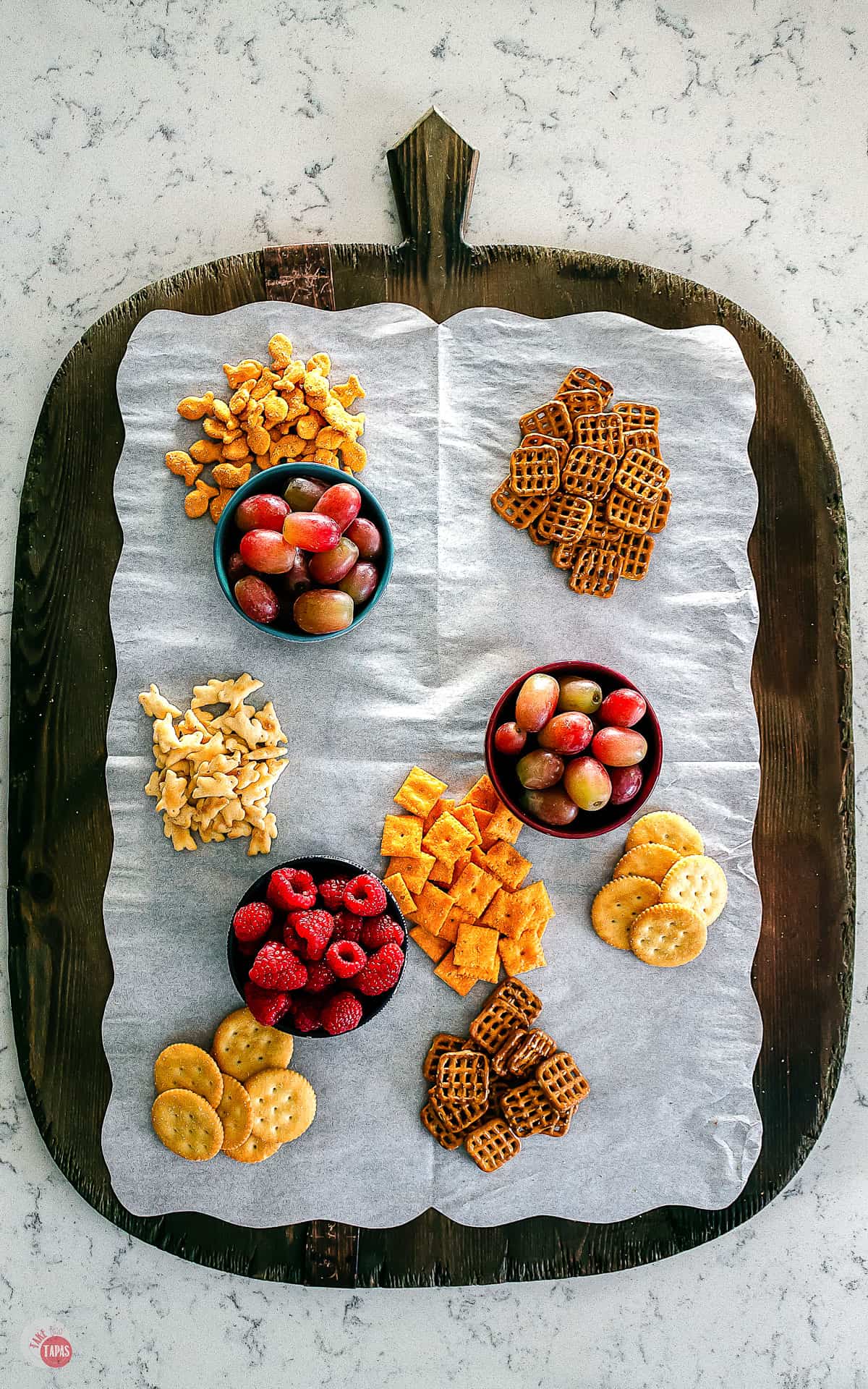 crackers and fruit on a platter