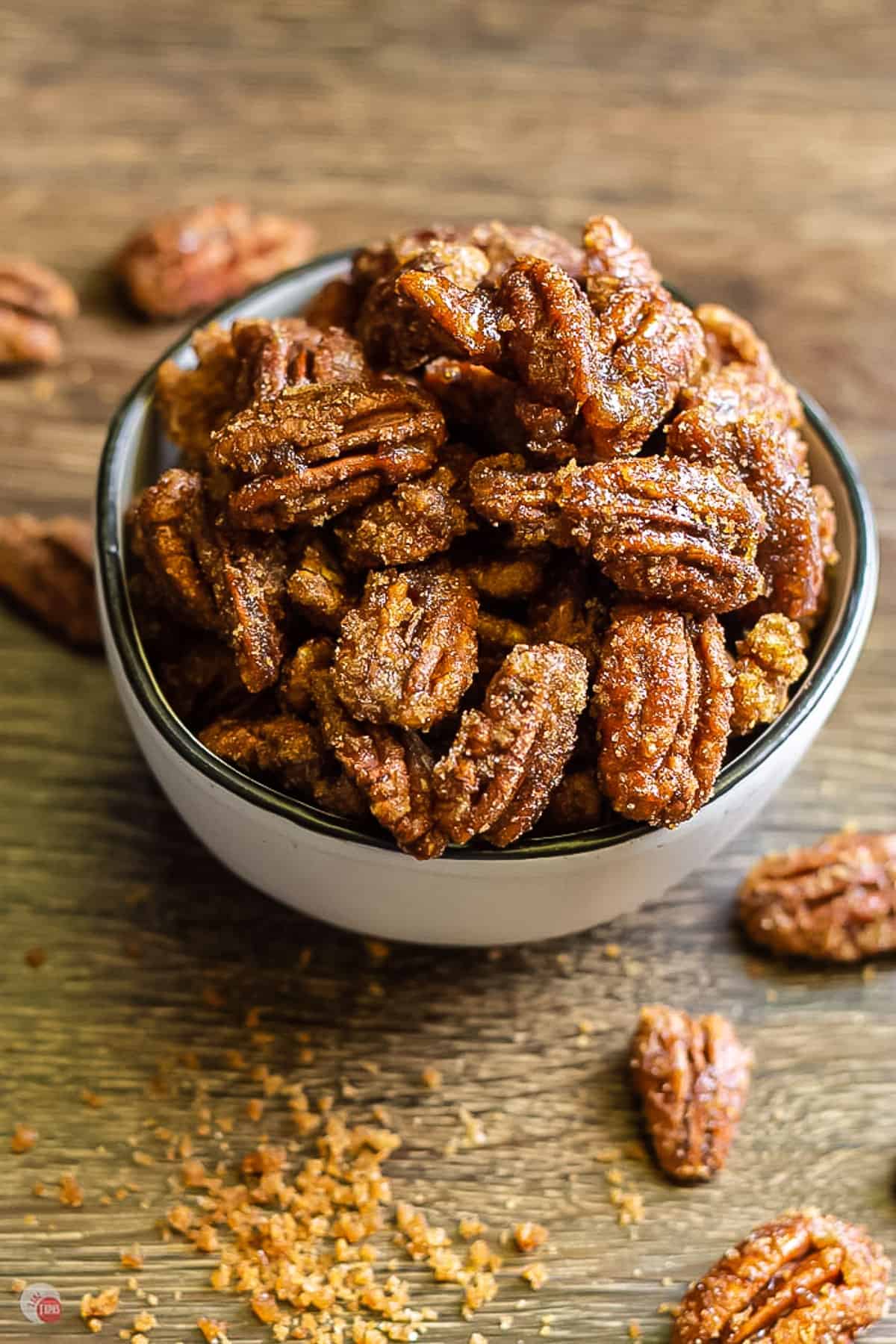 white bowl of gingersnap flavored candied pecans