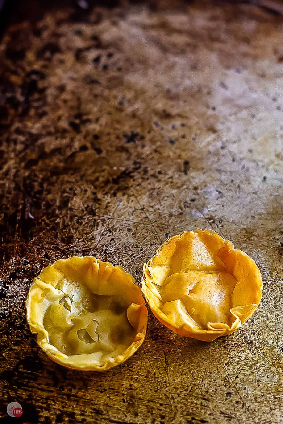 two phyllo cups on a baking pan