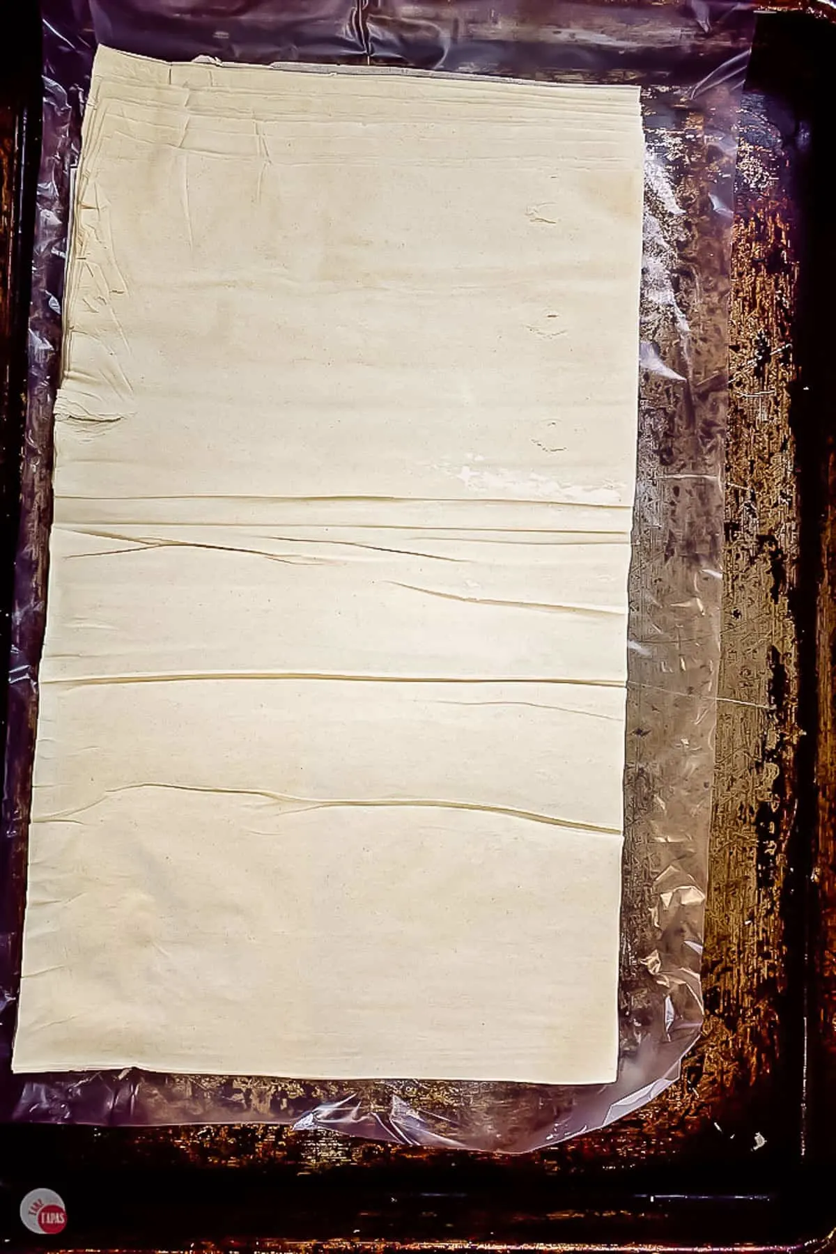 stack of phyllo sheets on a baking pan