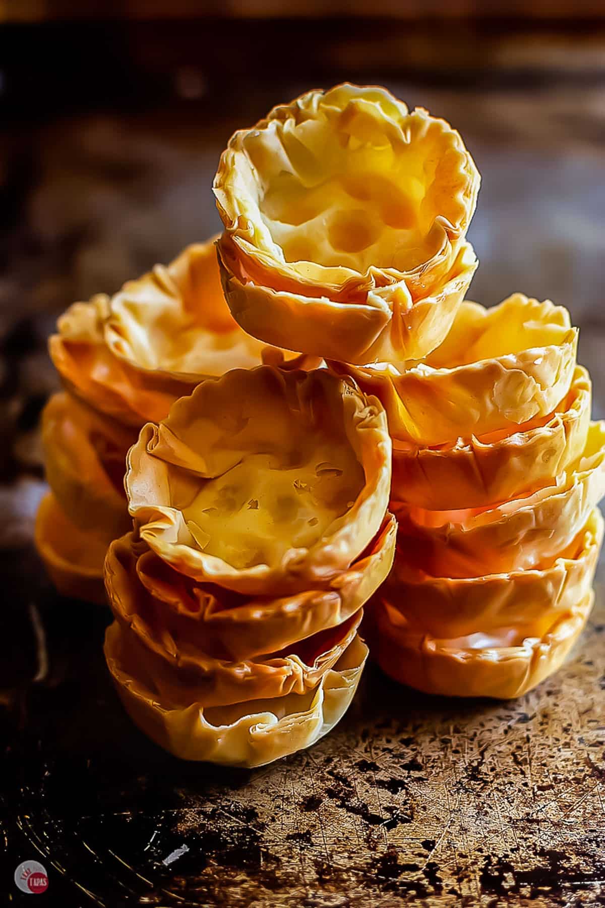 stacks of empty phyllo cups on a baking sheet
