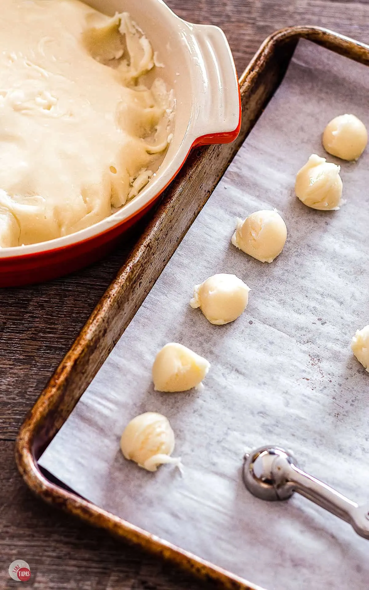 bowl of nougat, a parchment lined sheet pan with recently scooped nougat on it