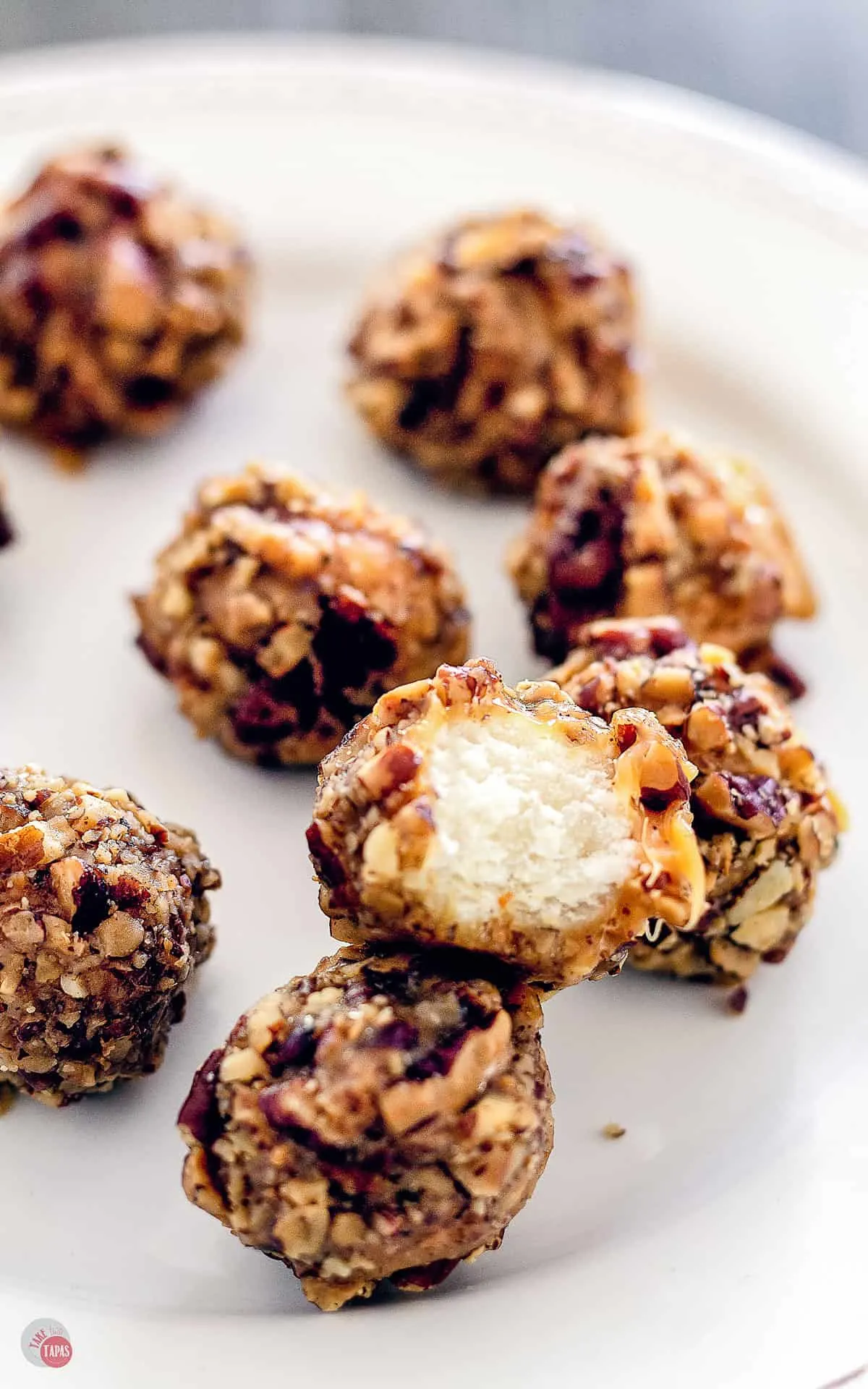 close up of Chewy nougat, covered in creamy caramel, and rolled in buttery toasted pecans.