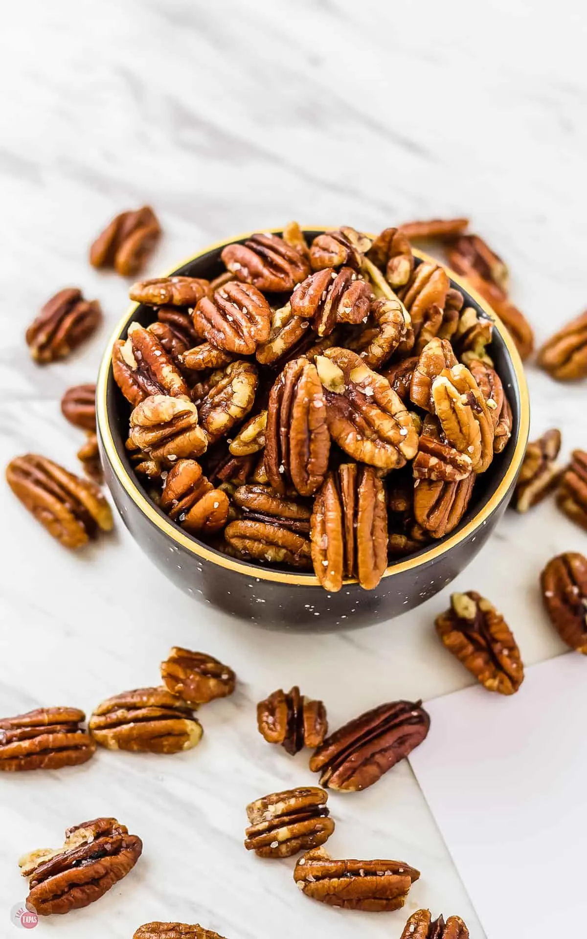 overhead shot of a bowl of perfect buttery toasted pecans