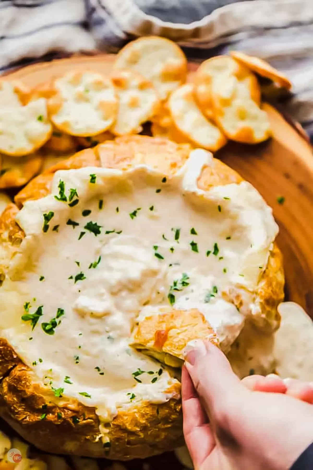 Close up of someone dipping their bread into a Dip Bowl