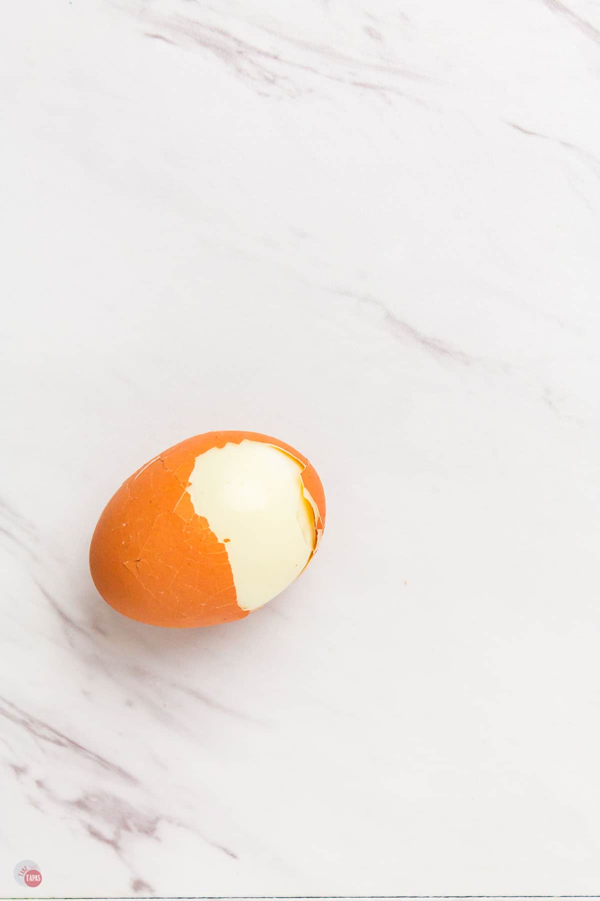 half peeled hard-boiled egg