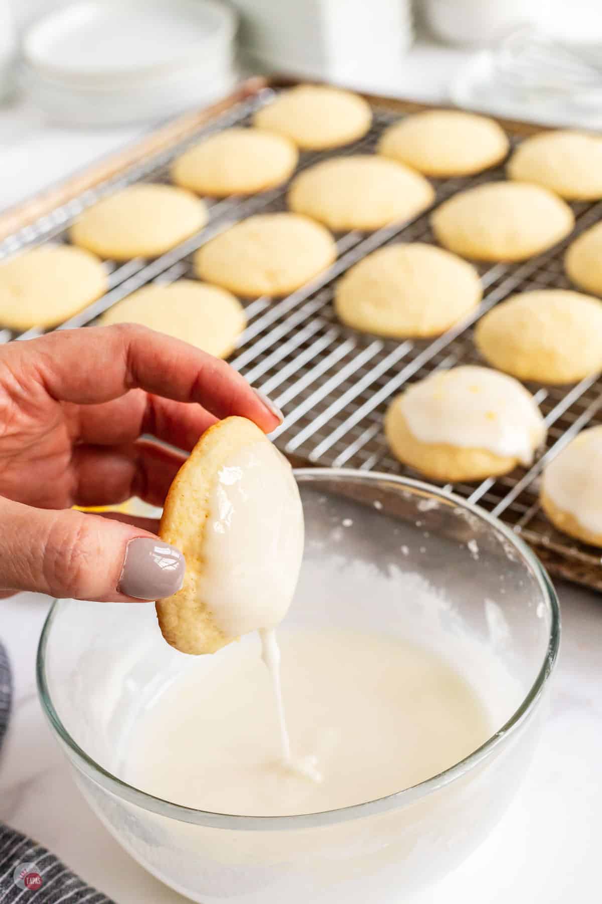 cookie being dipped into frosting