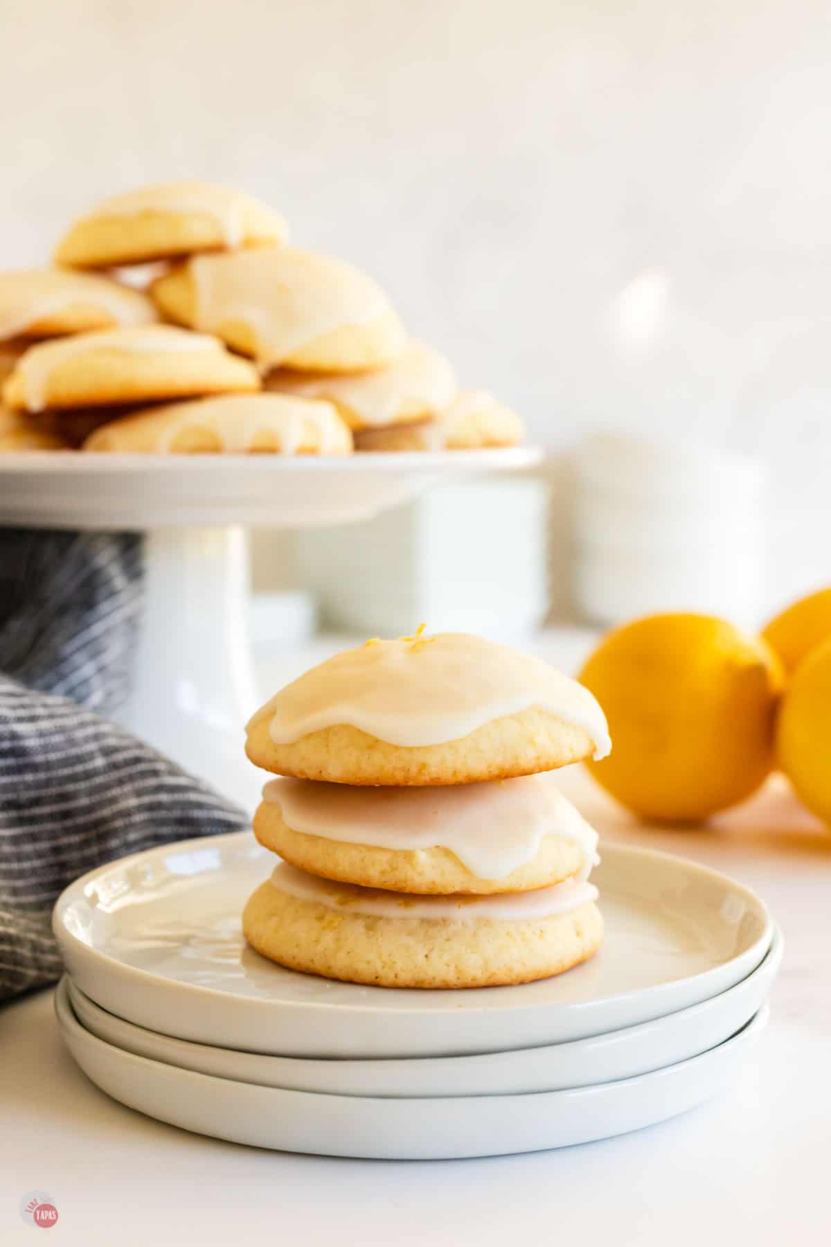 stack of lemon drop cookies on white plates