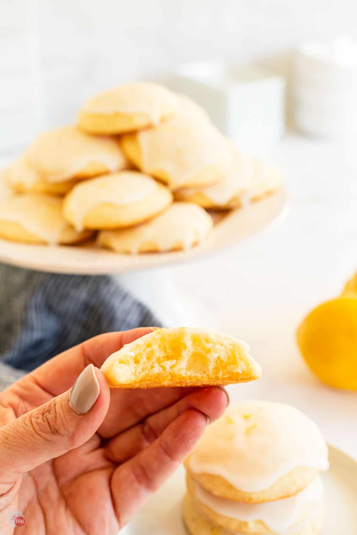 hand holding cookie with bite out of it