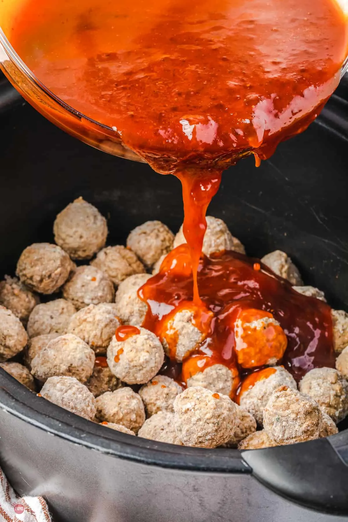 sauce pouring over meatballs