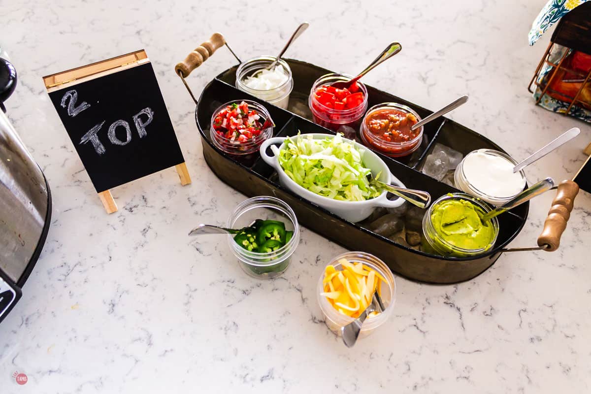 overhead picture of toppings for taco bar