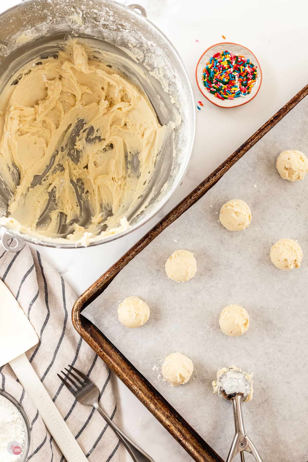 balls of cookie dough on a baking sheet