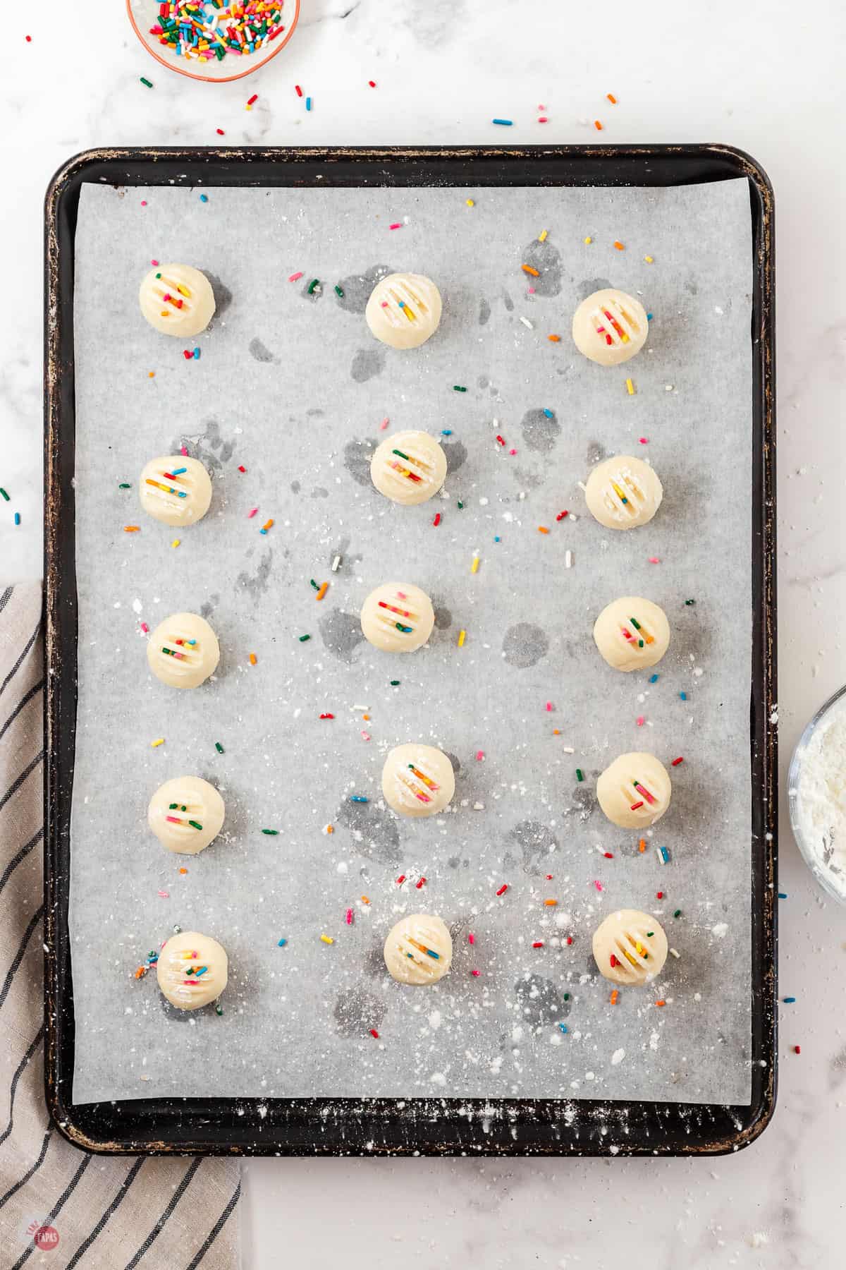 shortbread cookies with sprinkles on a baking sheet