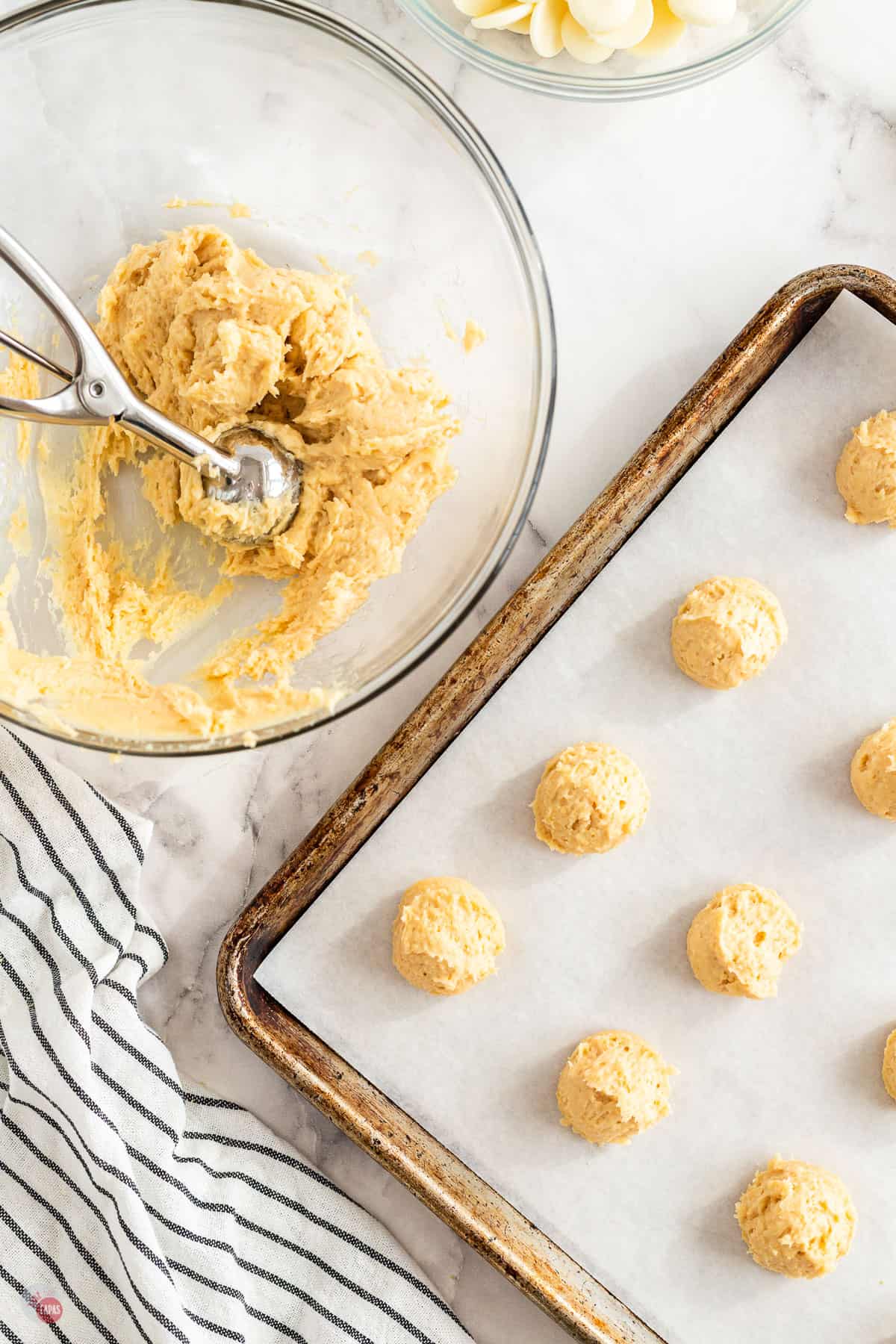 scoops of cookie dough on a baking sheet