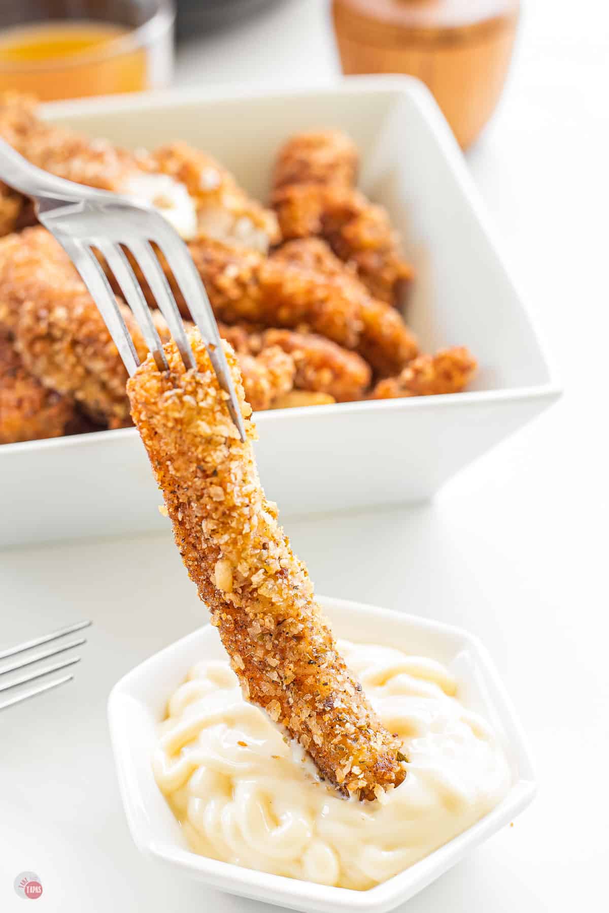 fish stick dipping in sauce